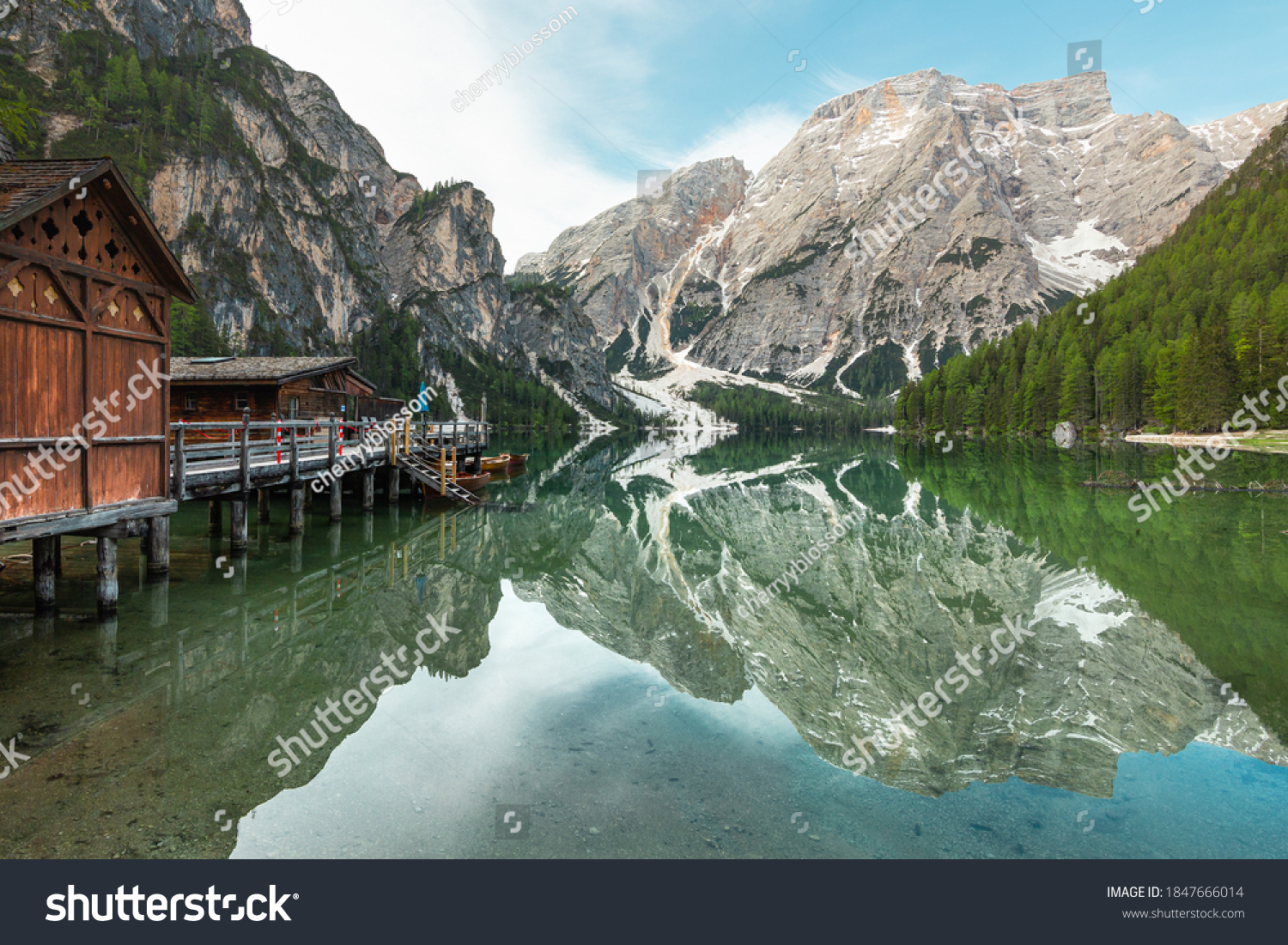 panoramic view of Mount Seekofel and boatshouse mirroring in the clear calm water of iconic mountain lake Pragser Wildsee (Lago di Braies) in Dolomites, Unesco World Heritage, South Tyrol, Italy #1847666014