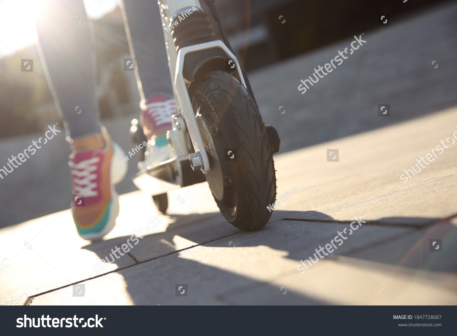 Woman riding electric kick scooter outdoors, closeup. Space for text #1847728687