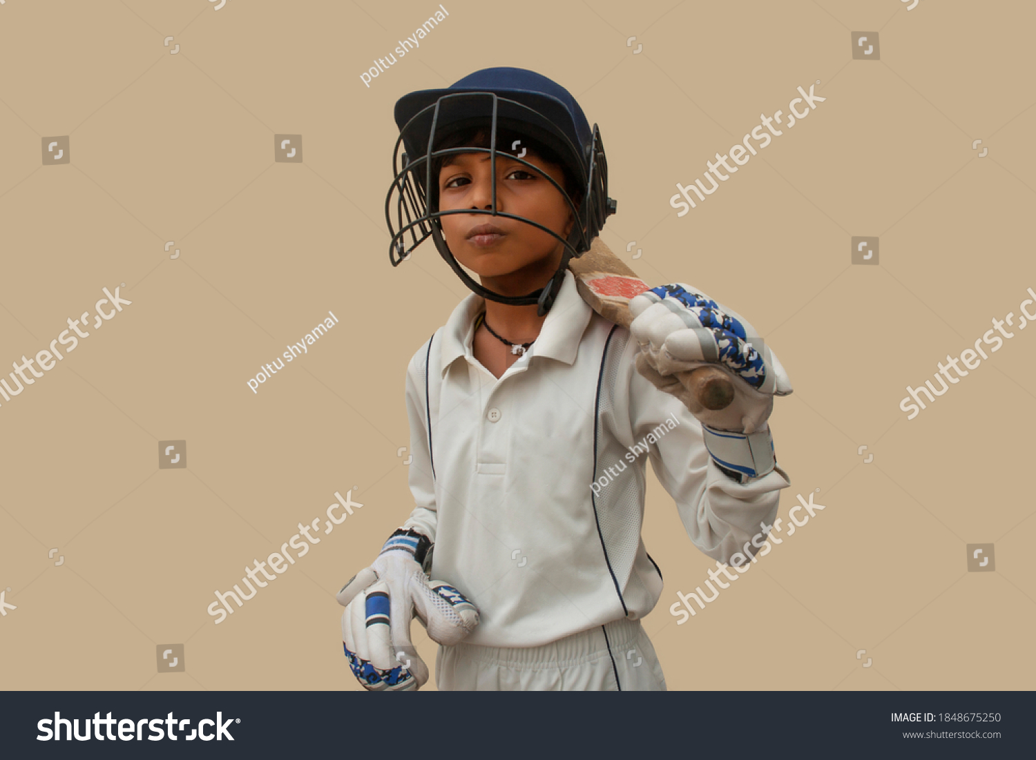 Confident boy wearing cricket helmet and ready for playing #1848675250