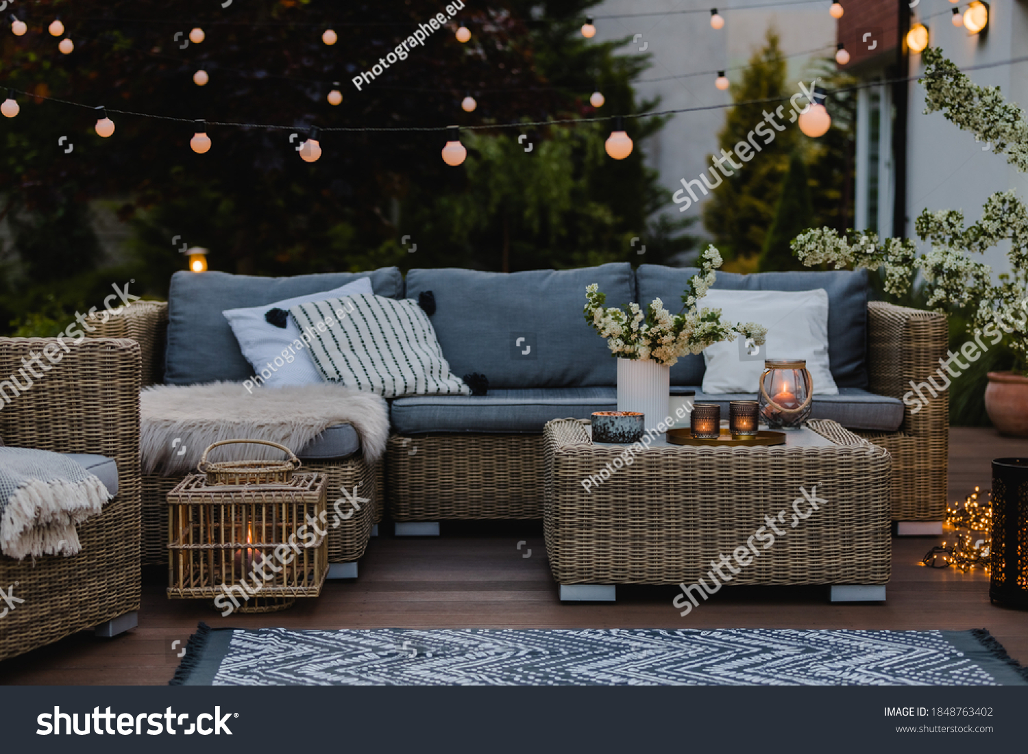 Summer evening on the patio of beautiful suburban house with garden #1848763402