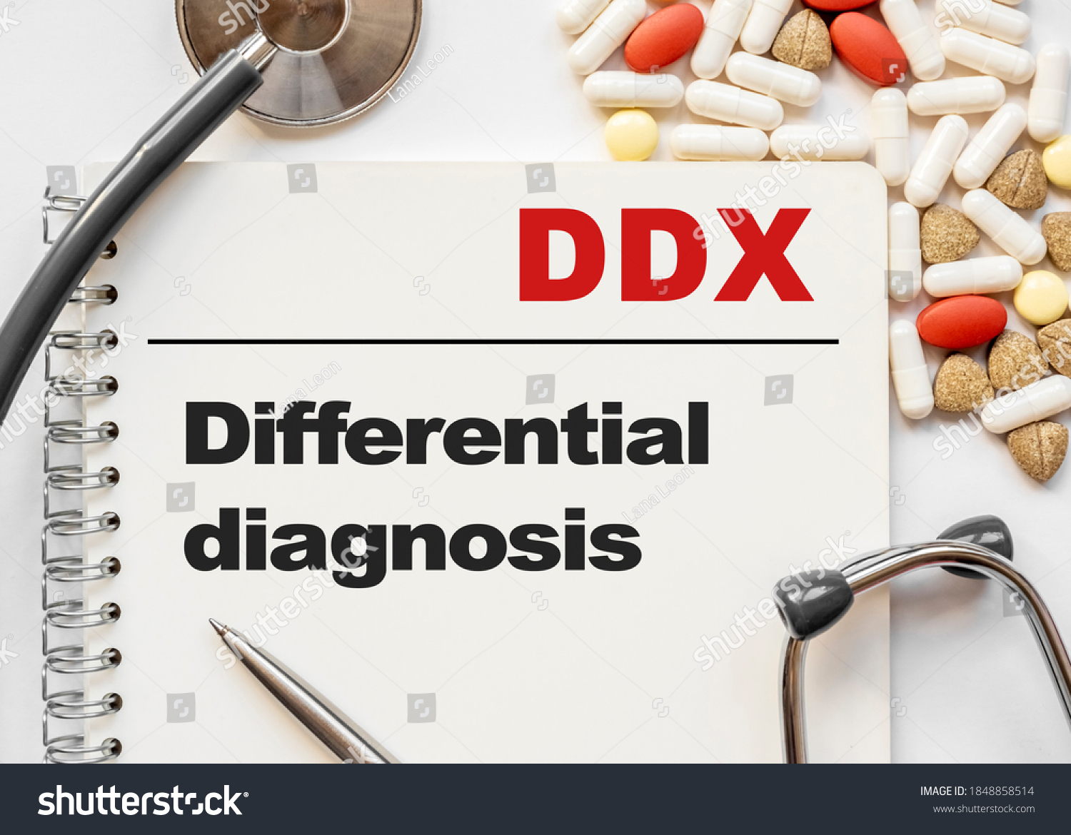 Page in notebook with DDX Differential diagnosis on white background with stethoscope and group of pill. Medical concept. Term and abbreviation #1848858514