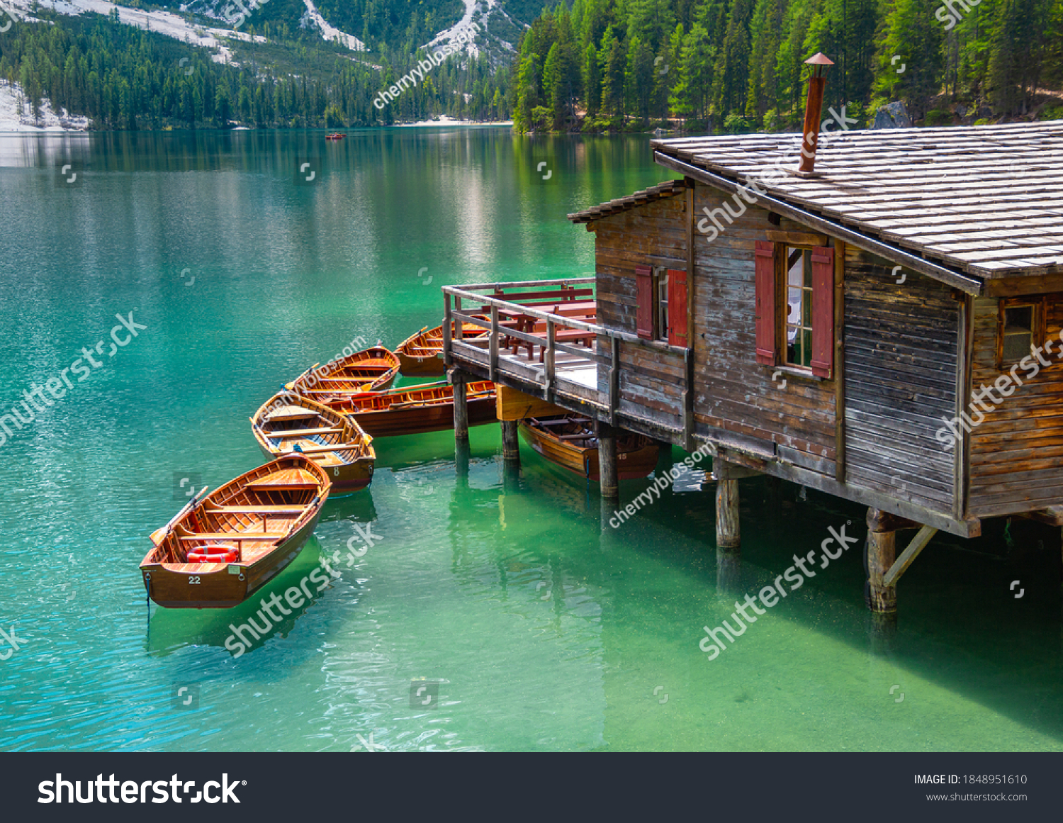 close up of boatshouse in the clear calm water of iconic mountain lake Pragser Wildsee (Lago di Braies) in Dolomites, Unesco World Heritage, South Tyrol, Italy #1848951610