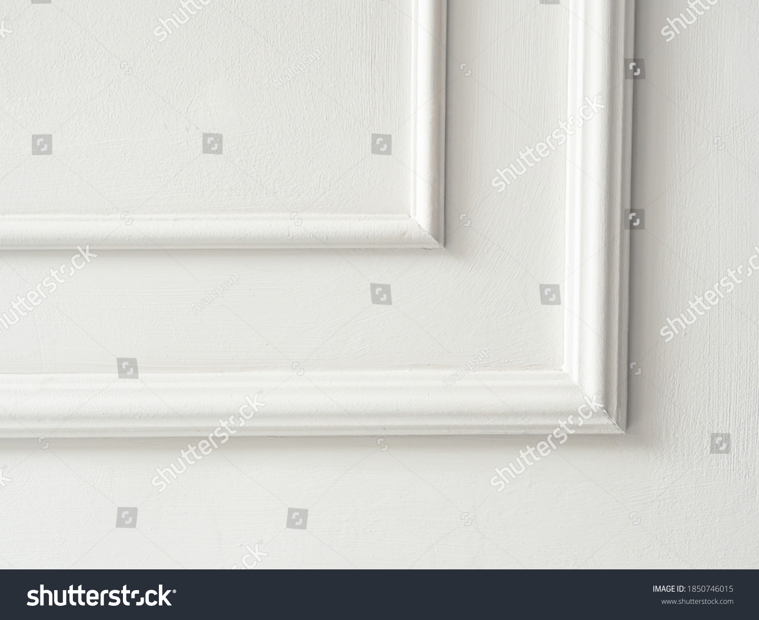 Beautiful ornate white decorative mouldings in studio. Decorative stucco in the classic interior of the house. The angle of the frame molding white for clipart. White cement plaster wall background. #1850746015