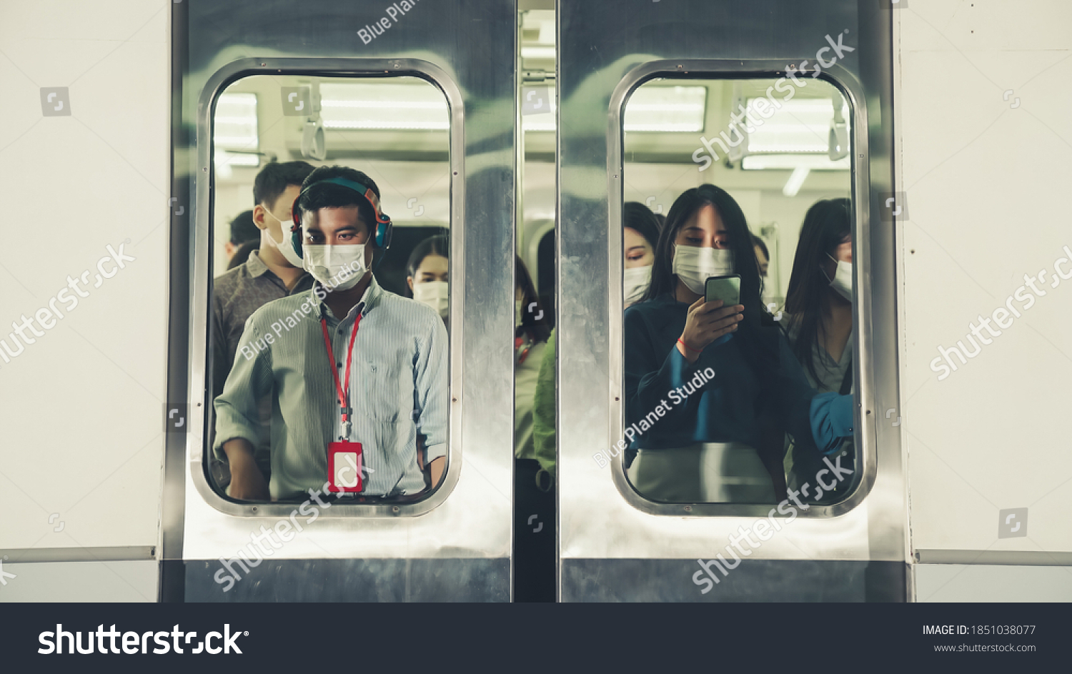 Crowd of people wearing face mask on a crowded public subway train travel . Coronavirus disease or COVID 19 pandemic outbreak and urban lifestyle problem in rush hour concept . #1851038077