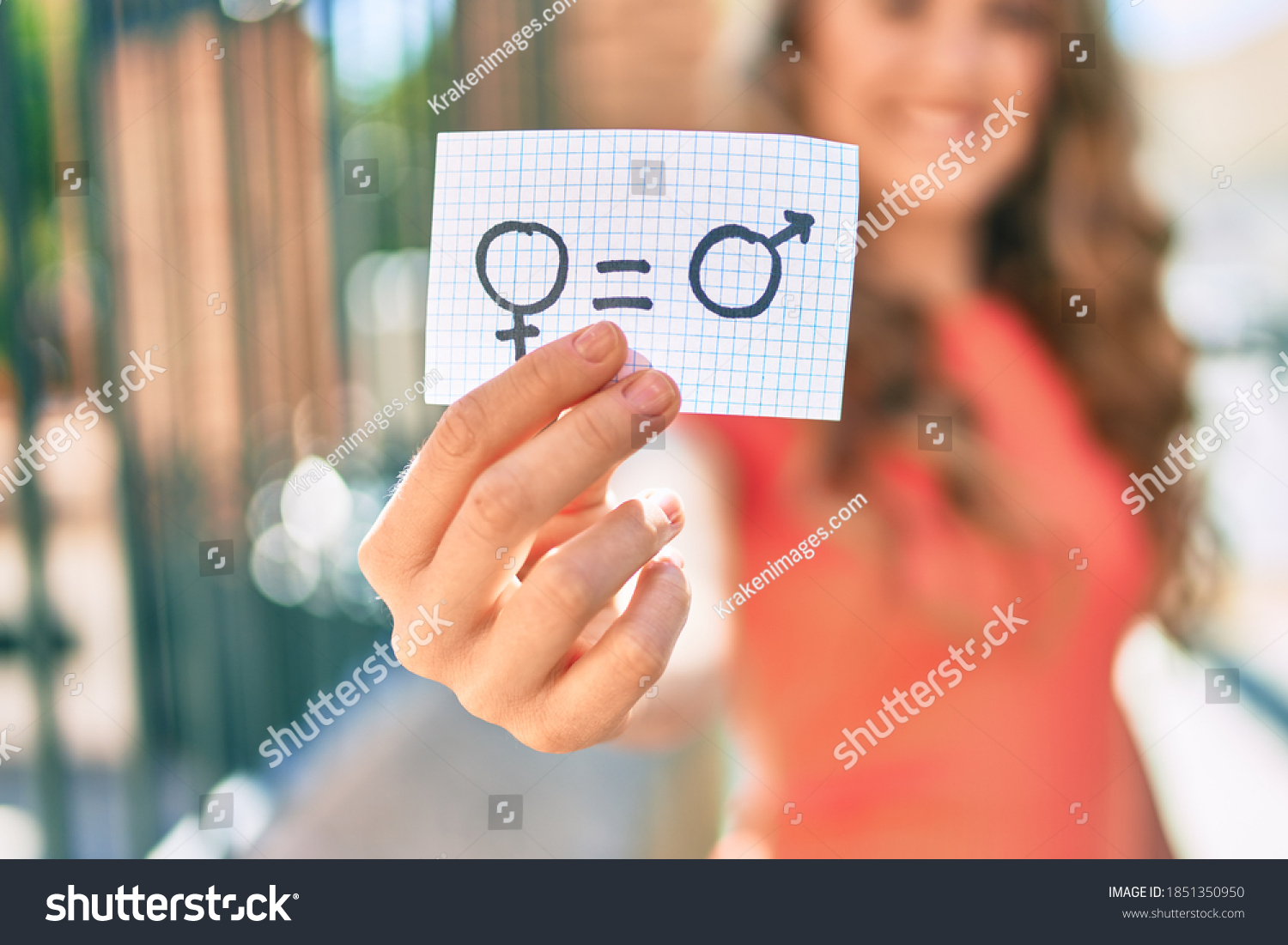 Young blonde girl smiling happy holding paper with gender equality concept walking at the city. #1851350950
