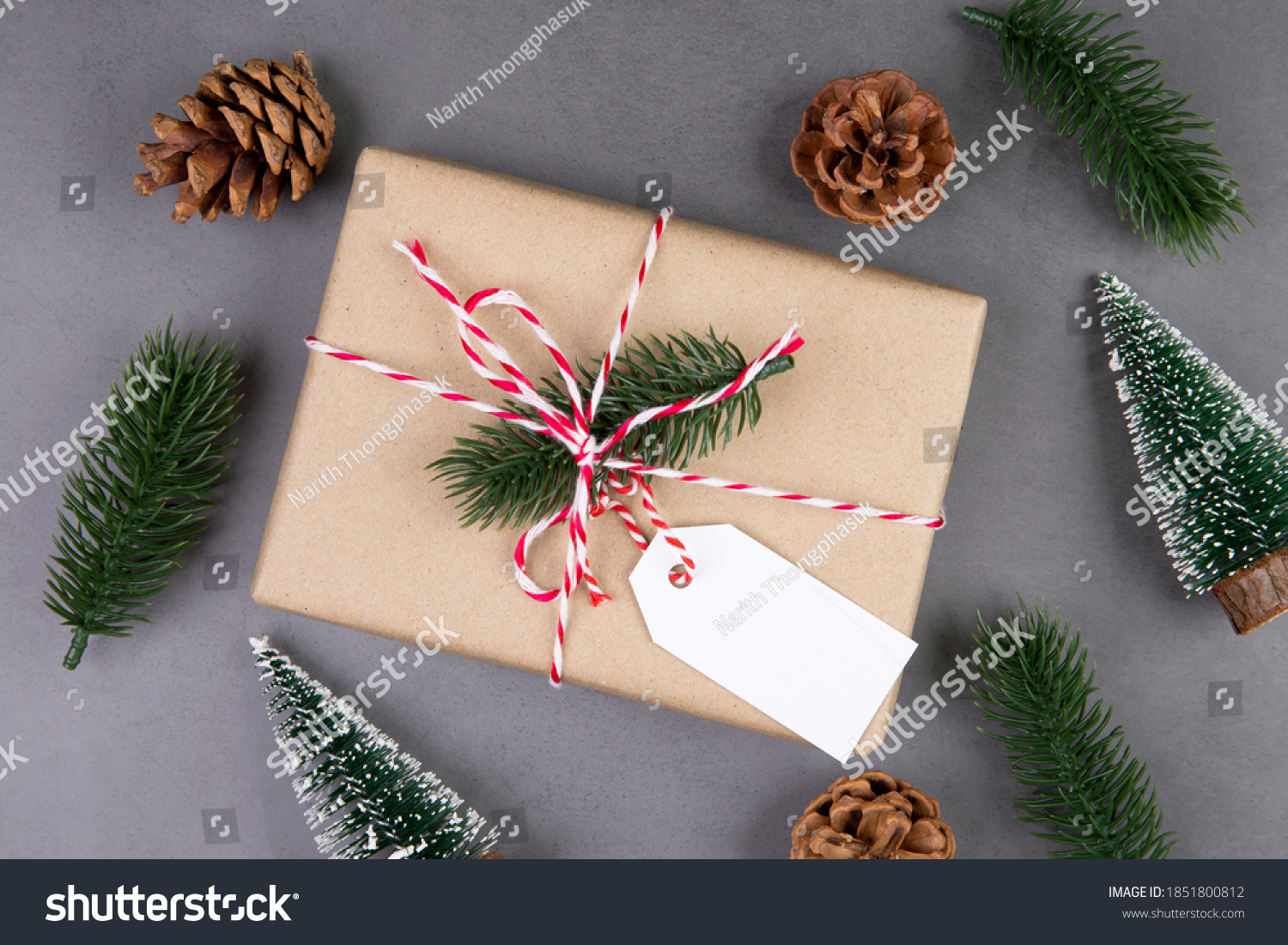 Christmas holiday composition with gift box having label decoration, new year and xmas or anniversary with presents having tag on cement floor background in season, top view or flat lay, copy space. #1851800812