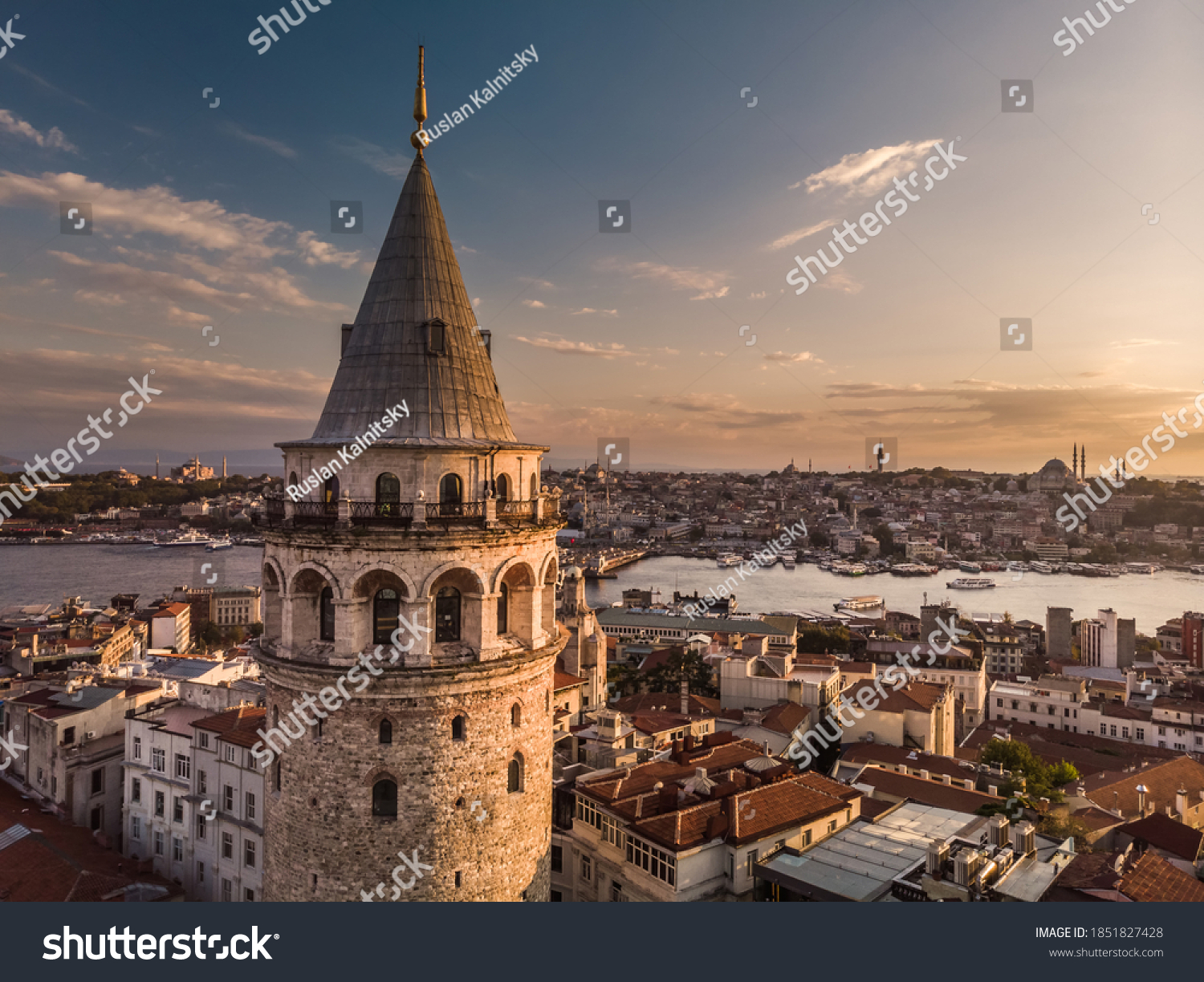 Aerial evening shot of the Galata Tower in Istanbul, Turkey. Aerial view of landmark at golden hour with beautiful sunlight. #1851827428
