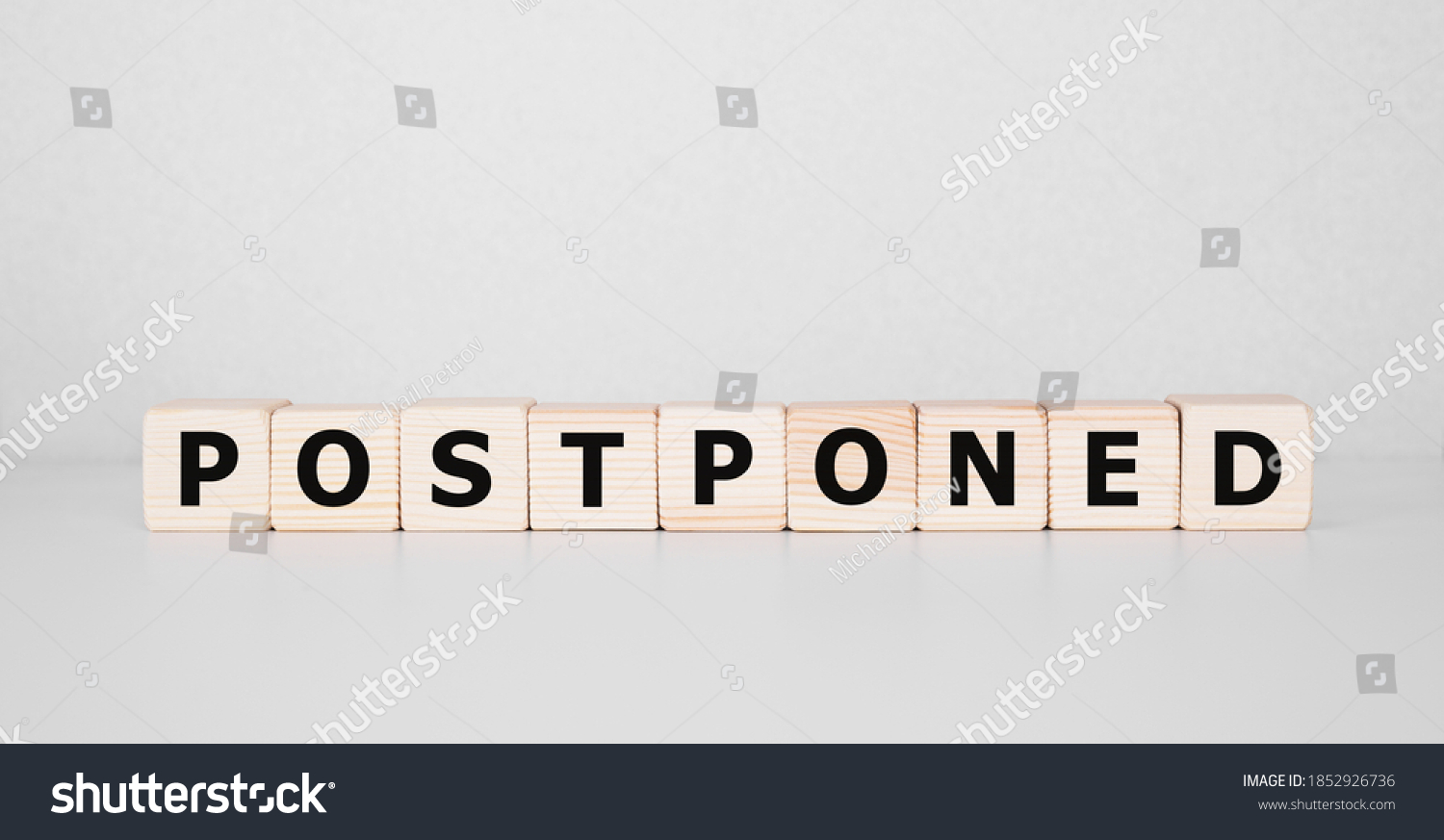 Postponed - words from wooden blocks with letters, postponed concept, top view background #1852926736