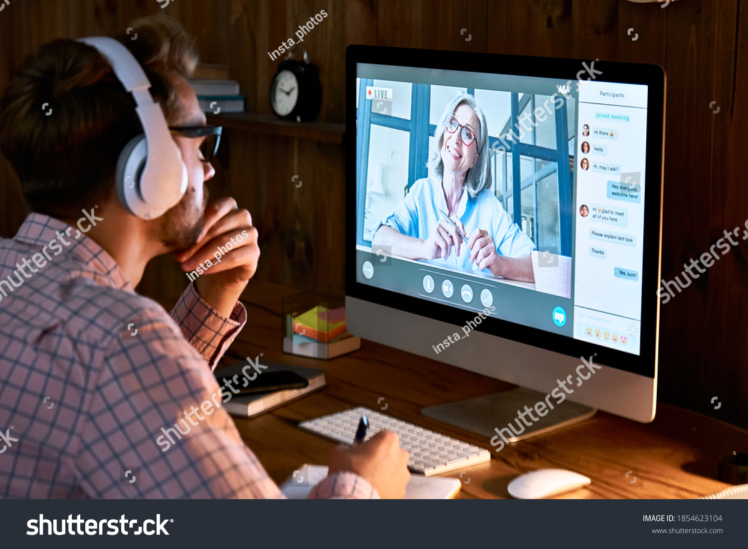 Male student wearing headphones taking online course training, watching webinar, remote seminar university class, virtual learning with social distance web teacher, tutor or coach on computer screen. #1854623104