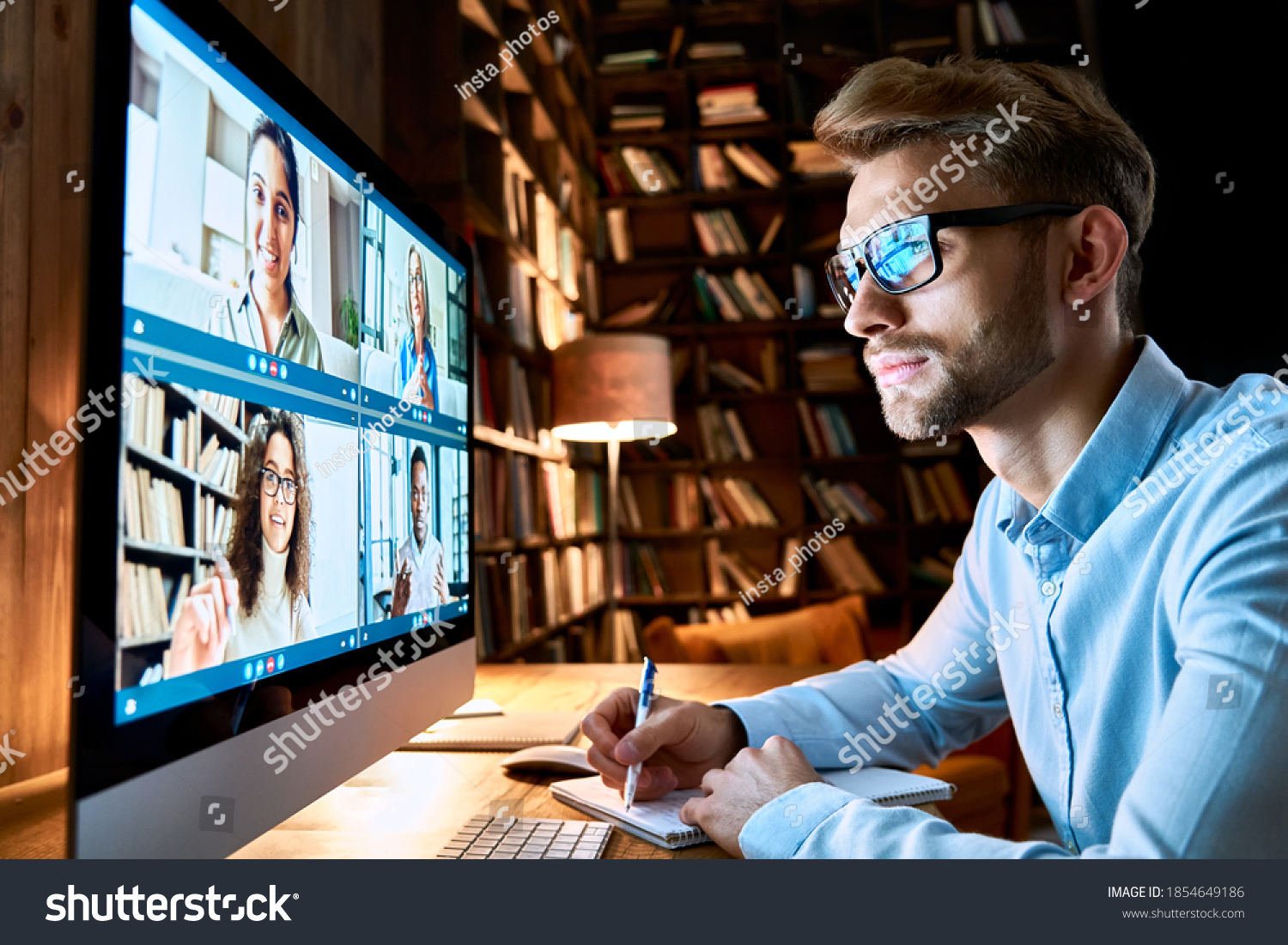 Business man having virtual team meeting on video conference call using computer. Social distance employee working from home office talking to diverse colleagues in remote videoconference online chat. #1854649186