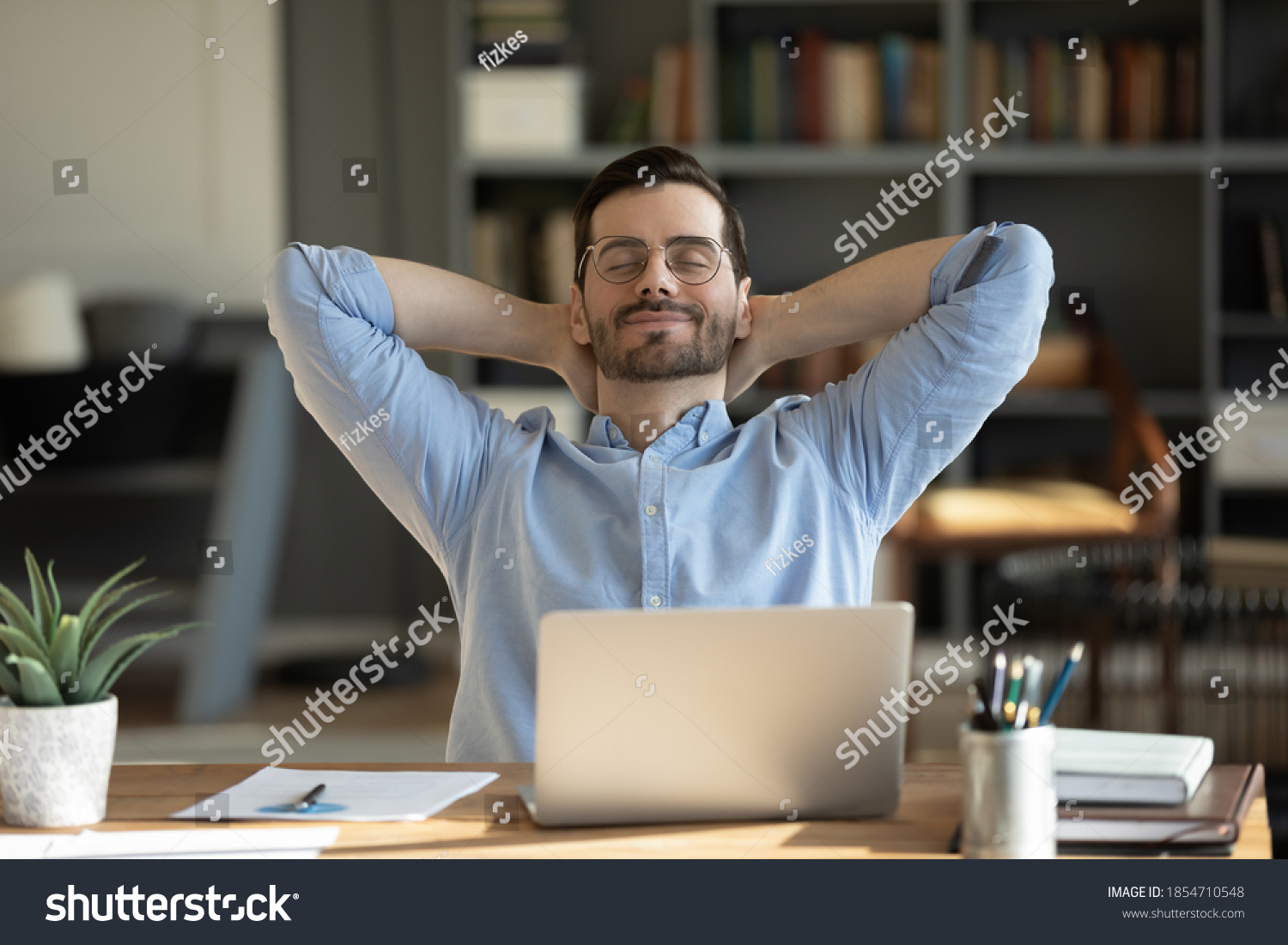 Relaxed man take break from work put hands behind head lean on comfy chair closing eyes feels serenity, enjoy fresh conditioned air in modern office, no stress, fatigue relieve at workplace concept #1854710548