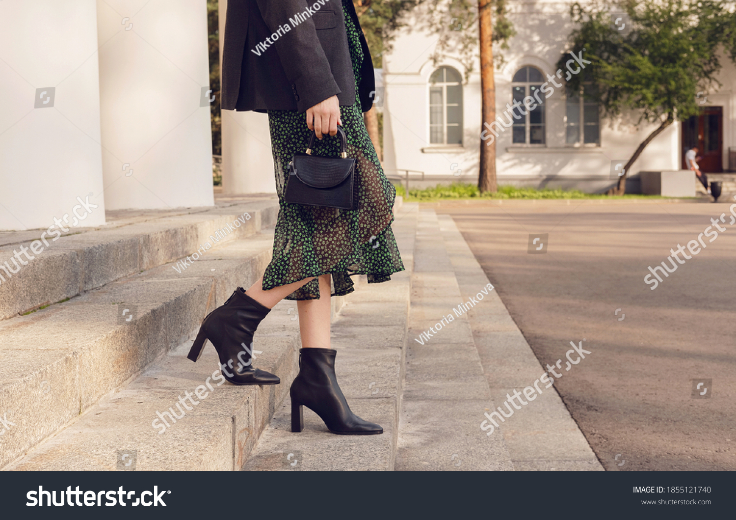 woman pose in black ankle boots with mini bag on the stairs, street style outfit #1855121740