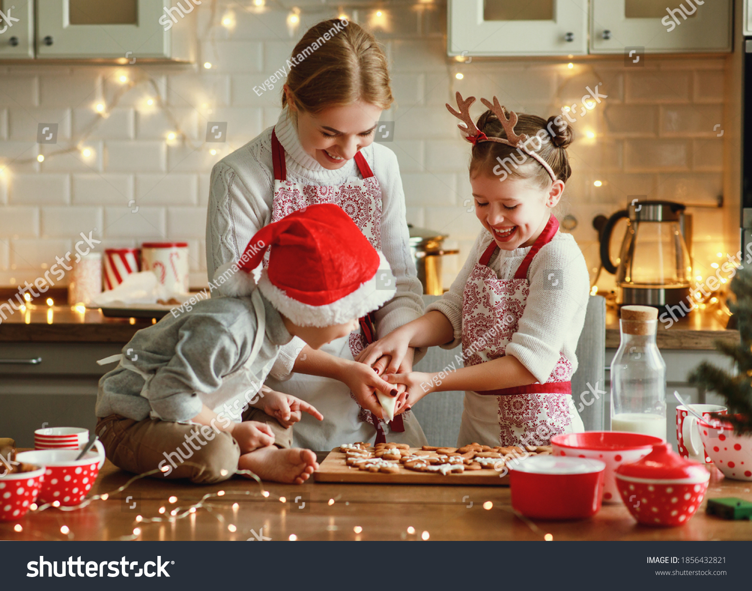happy funny family mother and children  bake christmas cookies on cozy kitchen at home #1856432821