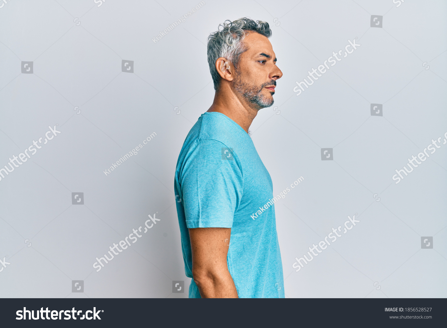 Middle age grey-haired man wearing casual clothes looking to side, relax profile pose with natural face with confident smile.  #1856528527