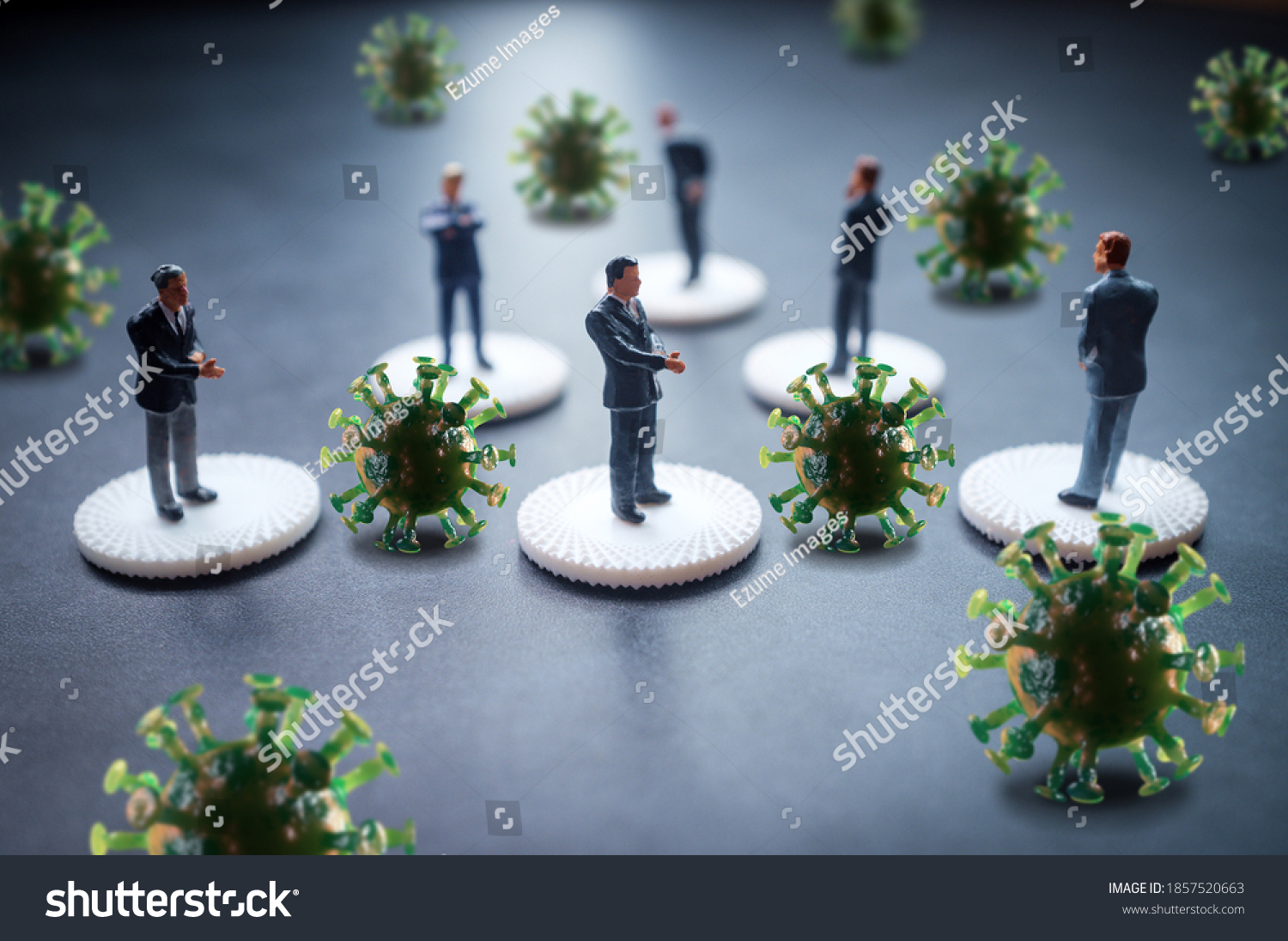 Miniature businessmen practicing social distancing to slow the spread of the deadly coronavirus #1857520663