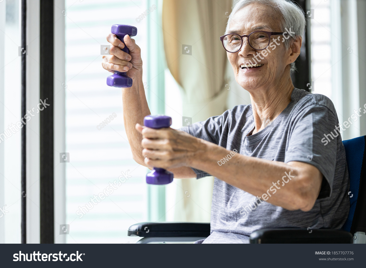 Strong asian senior woman working out with heavy dumbbells,lifting dumbbell weights for strength training,fitness elderly people doing exercise while sit in wheelchair,health care,healthy lifestyle #1857707776