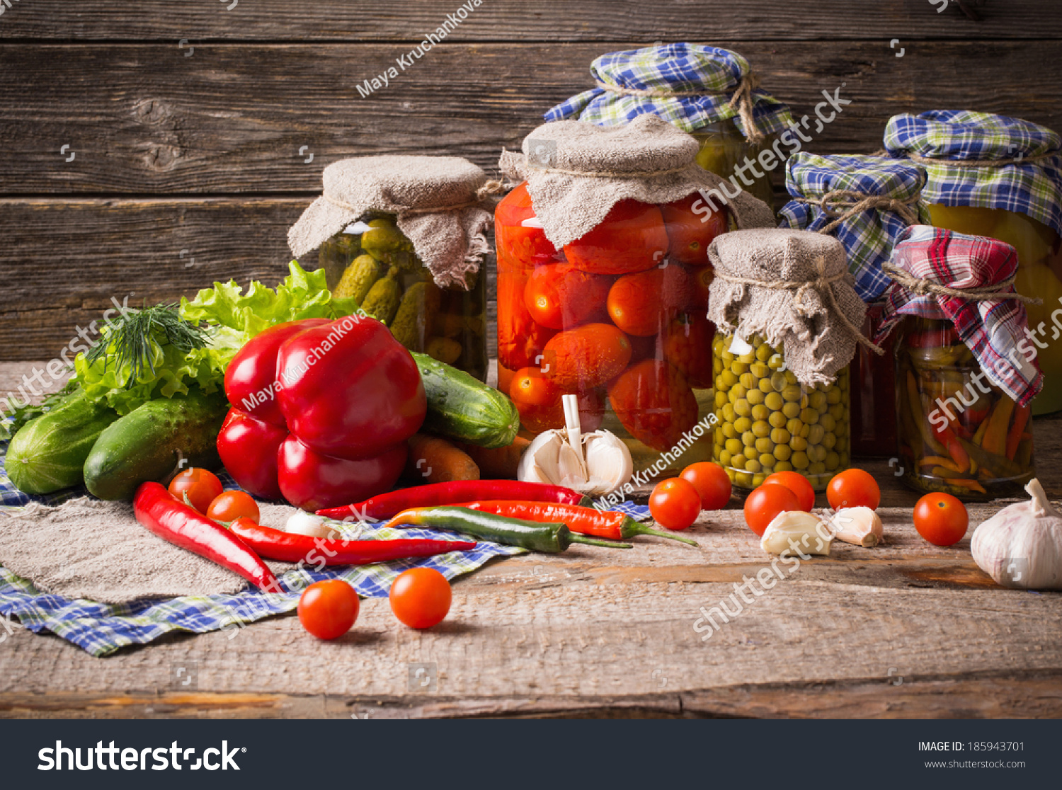 Preserved  and fresh vegetables on wooden background #185943701