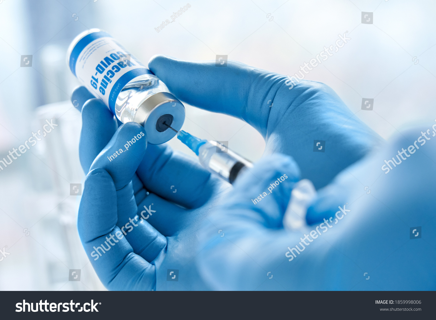 Male doctor hand wears medical glove holding syringe taking covid 19 corona virus liquid vaccine from vial bottle preparing for injections. Coronavirus immunization flu treatment vaccination concept. #1859998006