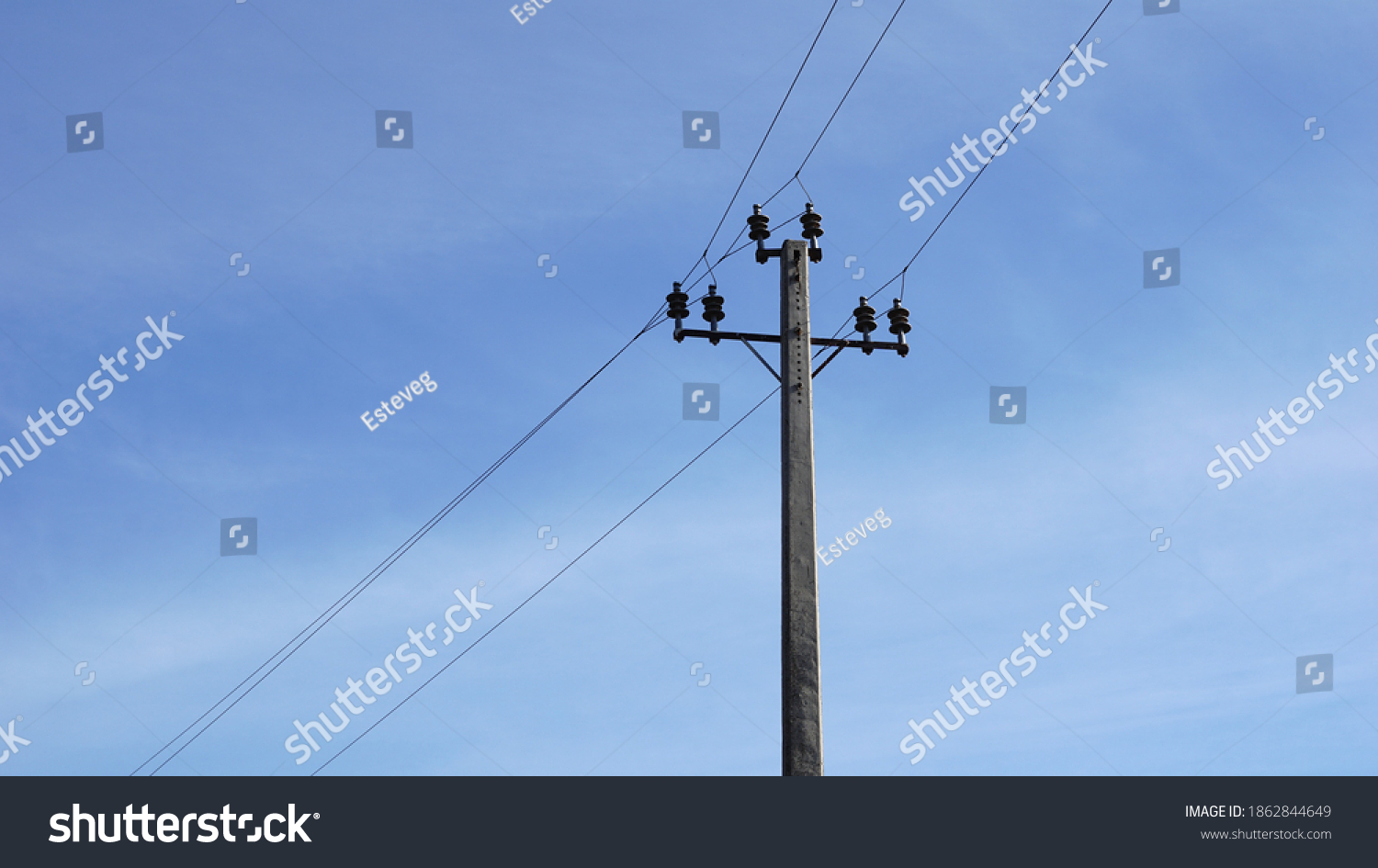 low voltage electricity post against blue background #1862844649