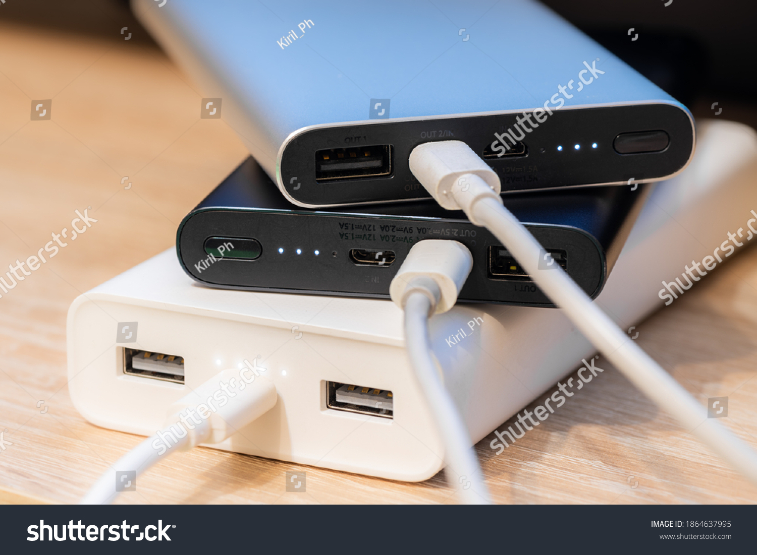 Portable  power banks in a charger process.   #1864637995