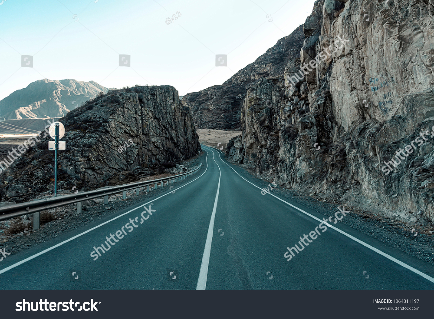 Road in mountains. The paved road passes through the rocks. Beautiful scenery. Chuysky tract in the Altai Republic. #1864811197