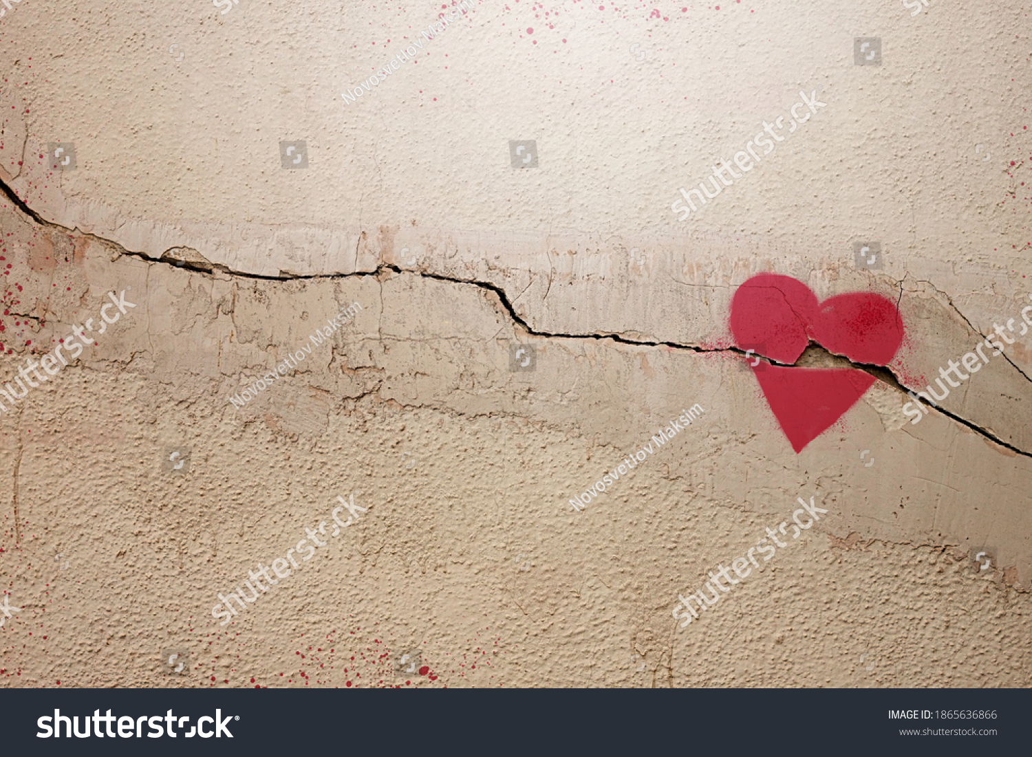 A heart painted on a cracked wall. The concept of broken heart, relationships, love, friendship, marriage, graffiti. #1865636866