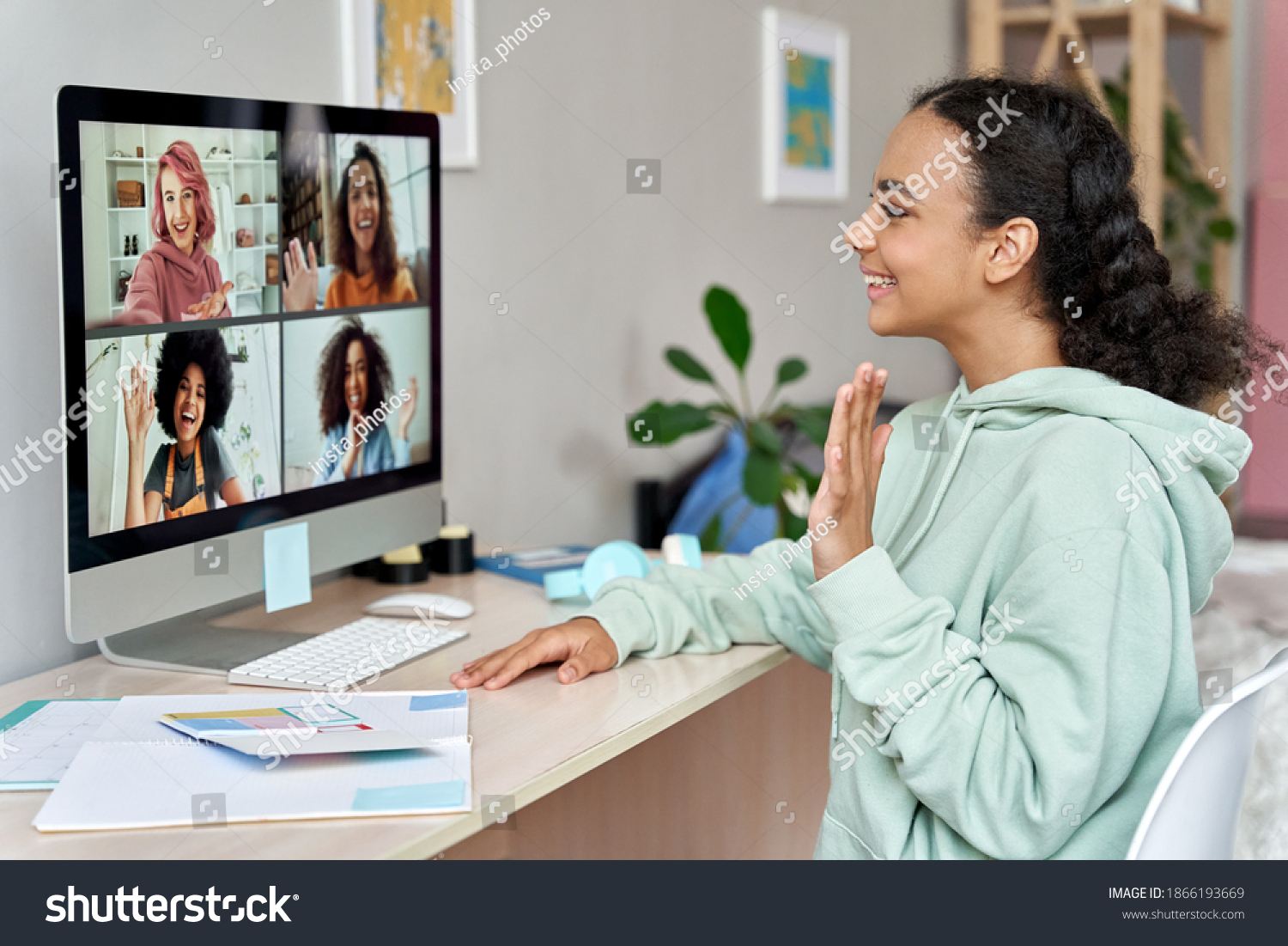 African american teen girl talking to happy multicultural diverse teenage friends during online virtual chat video call in group conference social distance chat virtual meeting using computer at home. #1866193669
