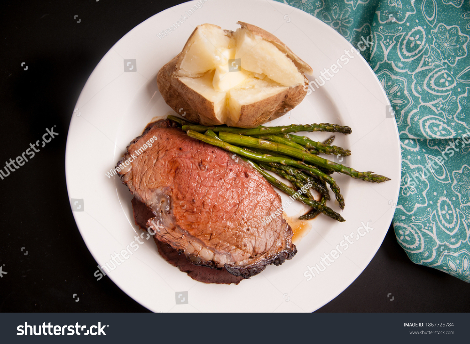 organic prime rib roast dinner with baked potato and asparagus #1867725784
