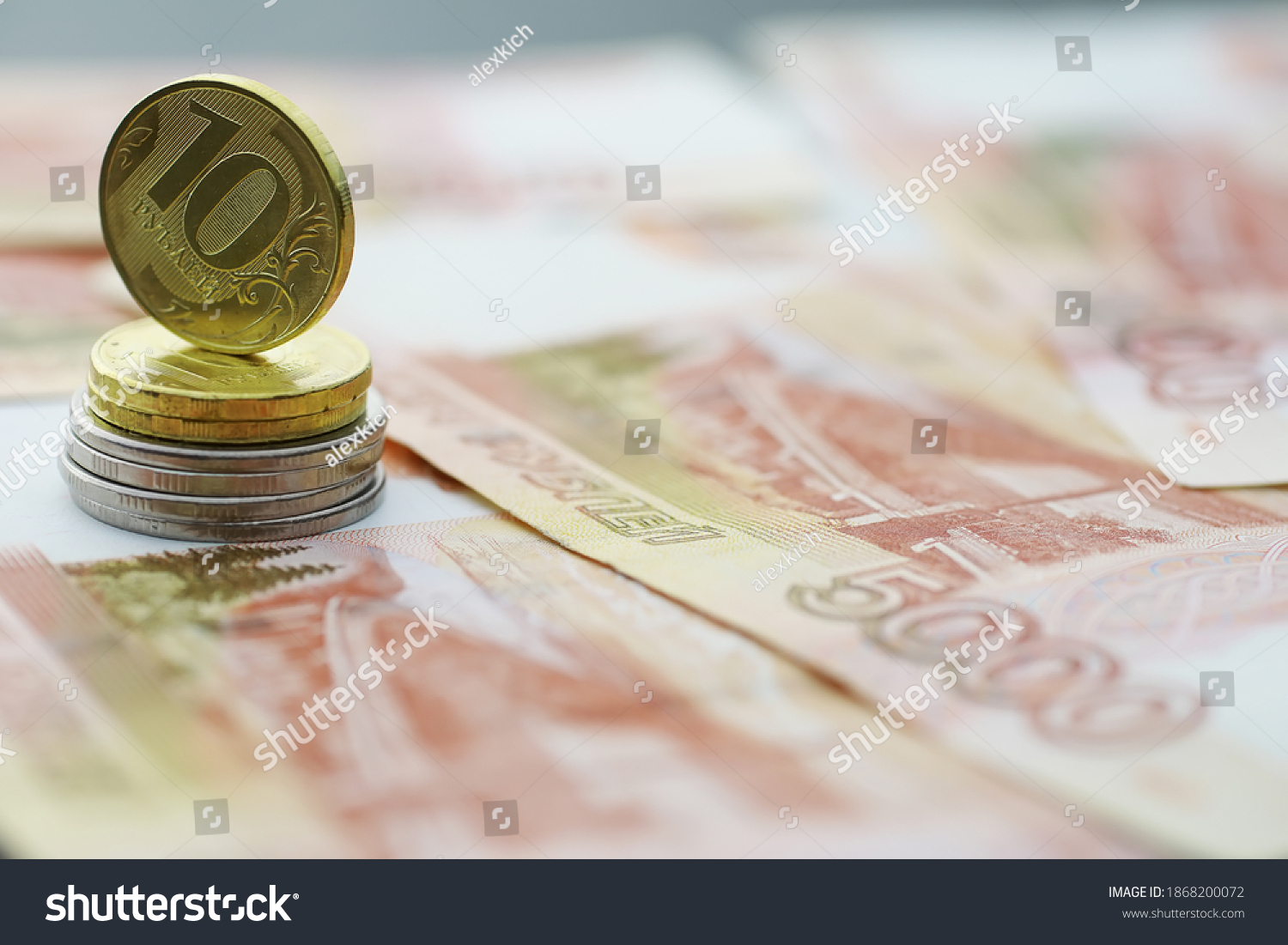 Russian banknotes and coins "rubles." Banknote with inscription "five thousand rubles" and coins of 5 and 10 rubles. Background made of money. #1868200072