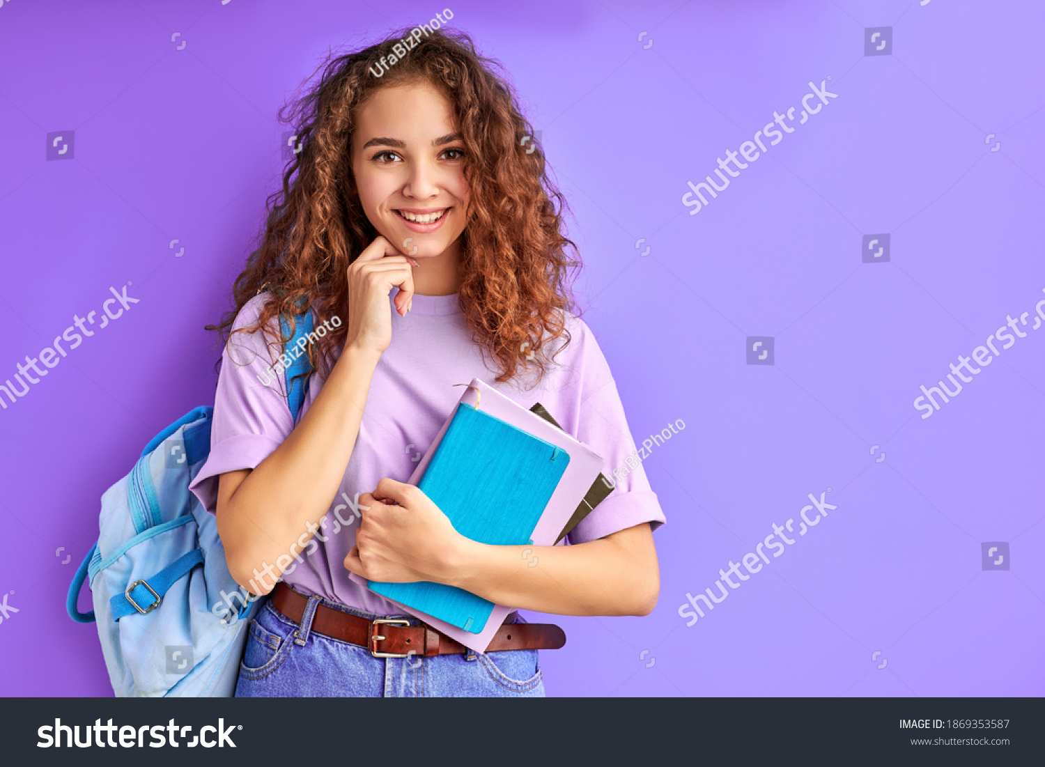sweet caucasian friendly young student girl holding colorful exercise books, ready to study #1869353587