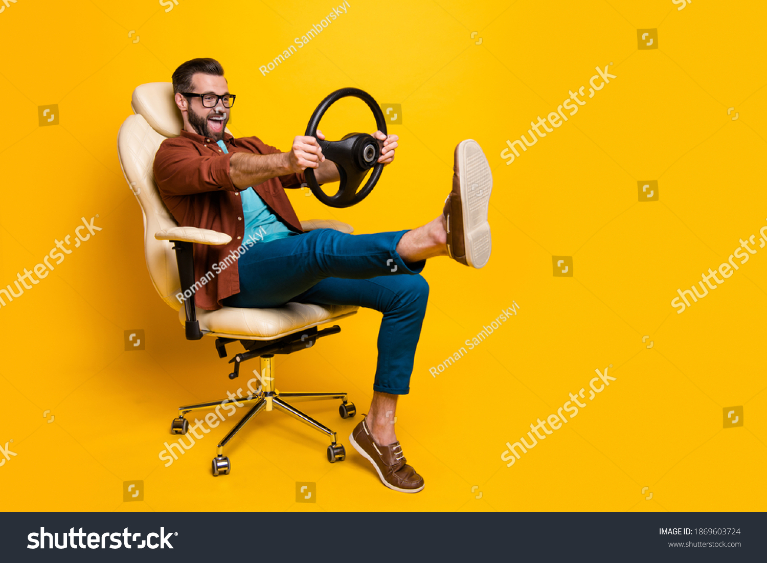 Full length body photo of happy fooling man in chair keeping steering wheel pretending car driver isolated vivid yellow color background #1869603724