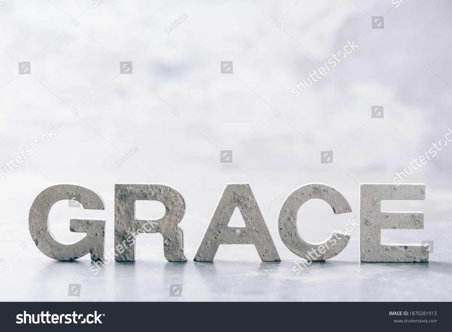 Word GRACE made with cement letters on grey marble background. Copy space. Biblical, spiritual or christian reminder. #1870281913