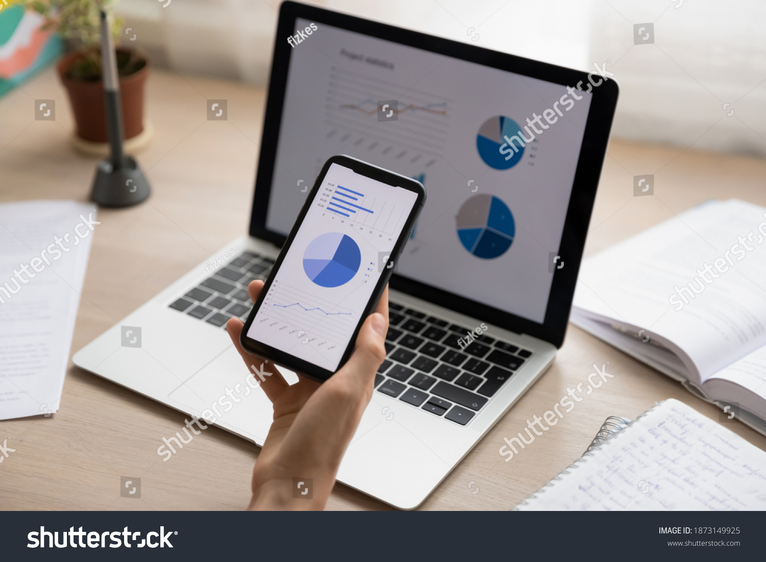 Close up businesswoman holding working with project statistics on devices, presentation with graphs and diagrams on laptop and phone screens, entrepreneur accountant analyzing financial data #1873149925