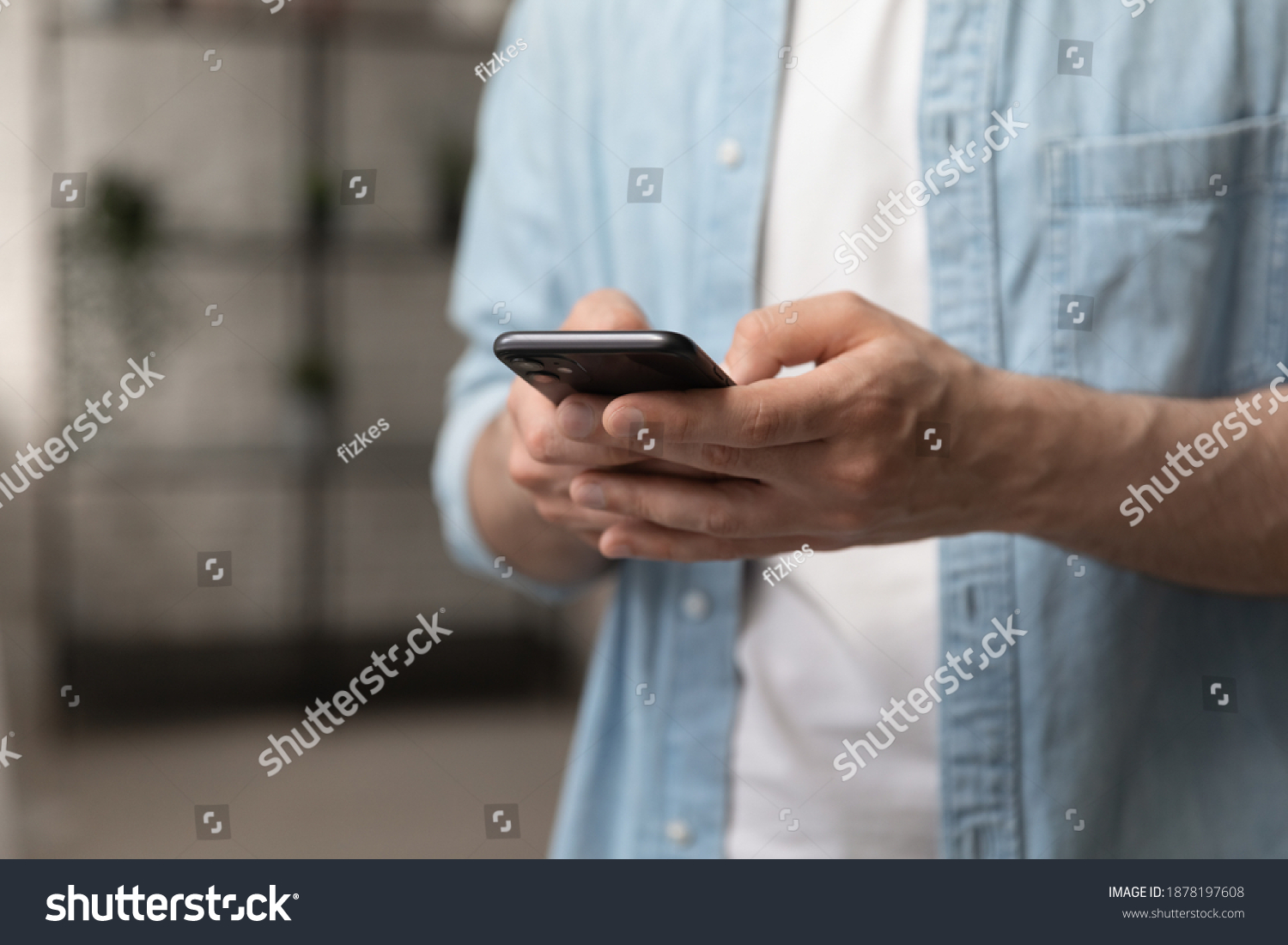 Virtual communication. Male hands holding new smartphone model touching sensor screen to browse internet. Close up of man viewing website social network connecting with shop bank chatting using cell #1878197608