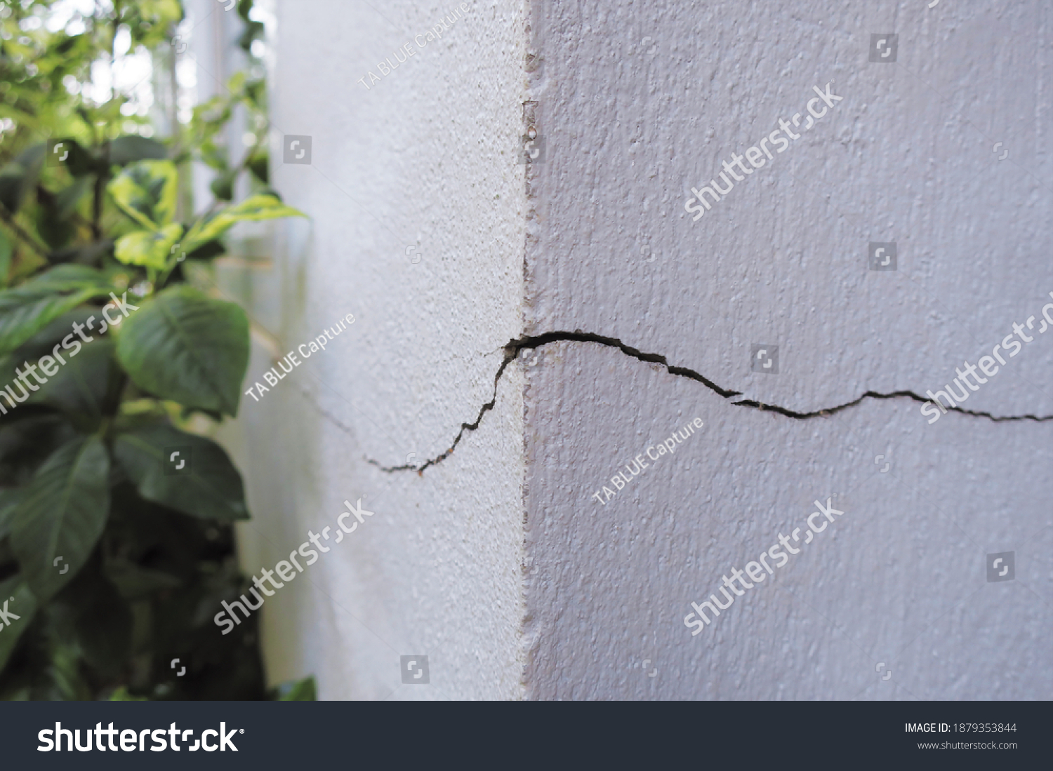 Cracked concrete building broken wall at the outside cement corner that effected with earthquake and collapsed ground #1879353844