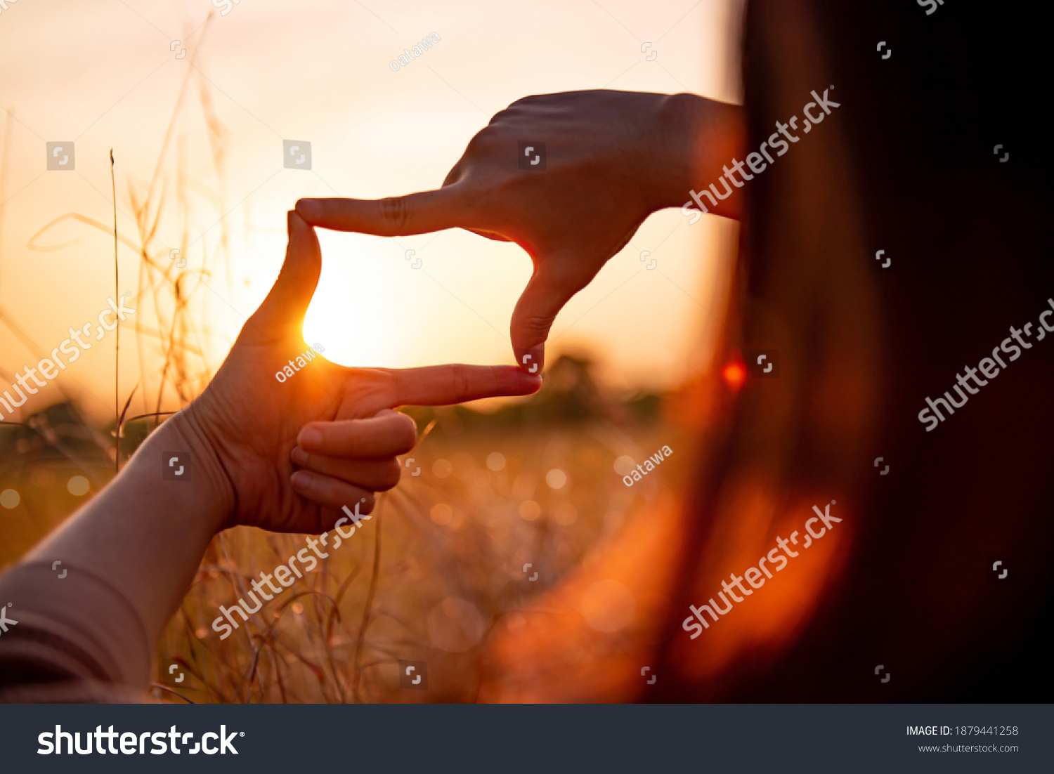 New year planning and vision concept, Close up of woman hands making frame gesture with sunset, Female capturing the sunrise. #1879441258