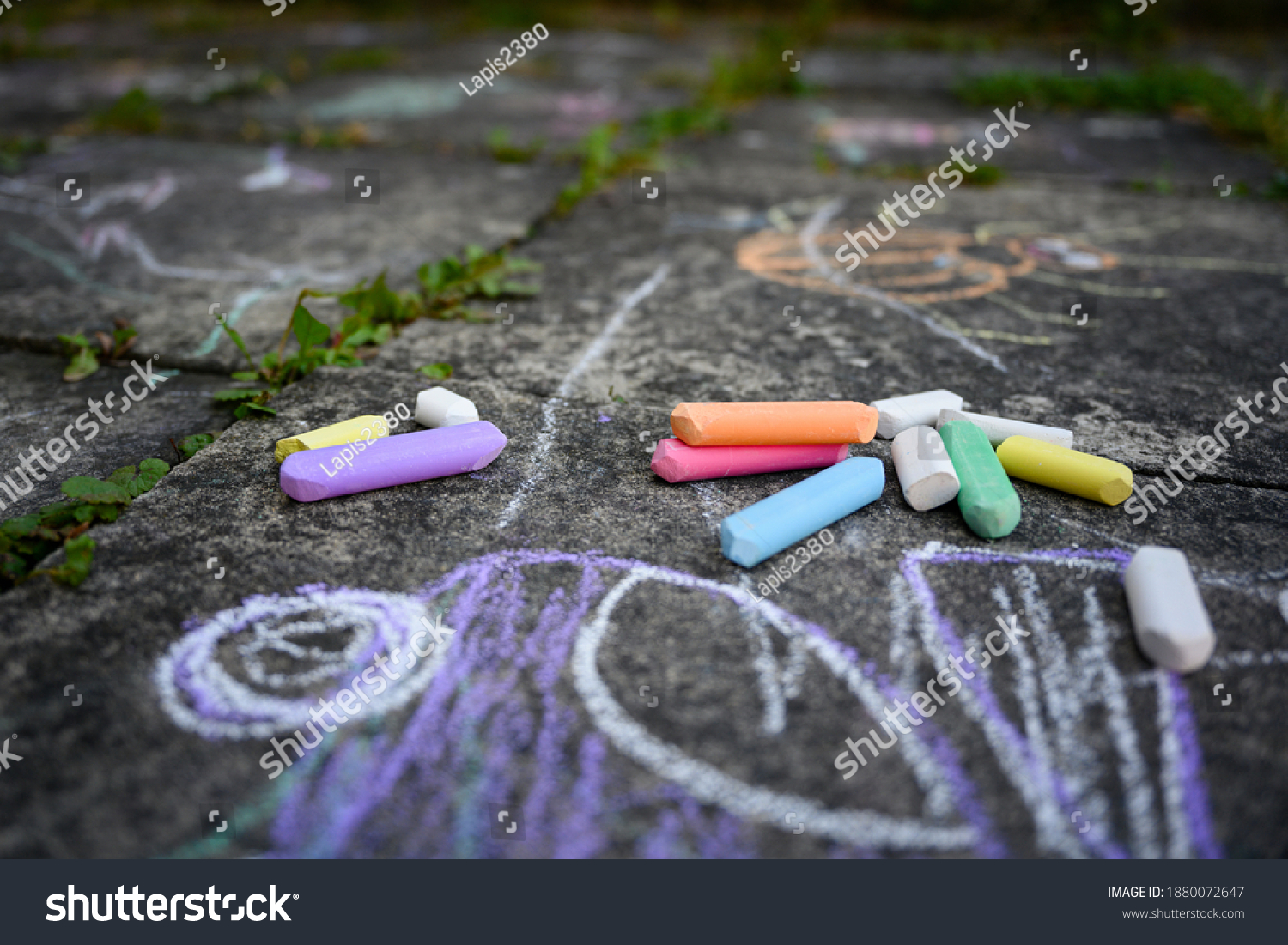 Children's drawing and colored chalks on a tile. #1880072647