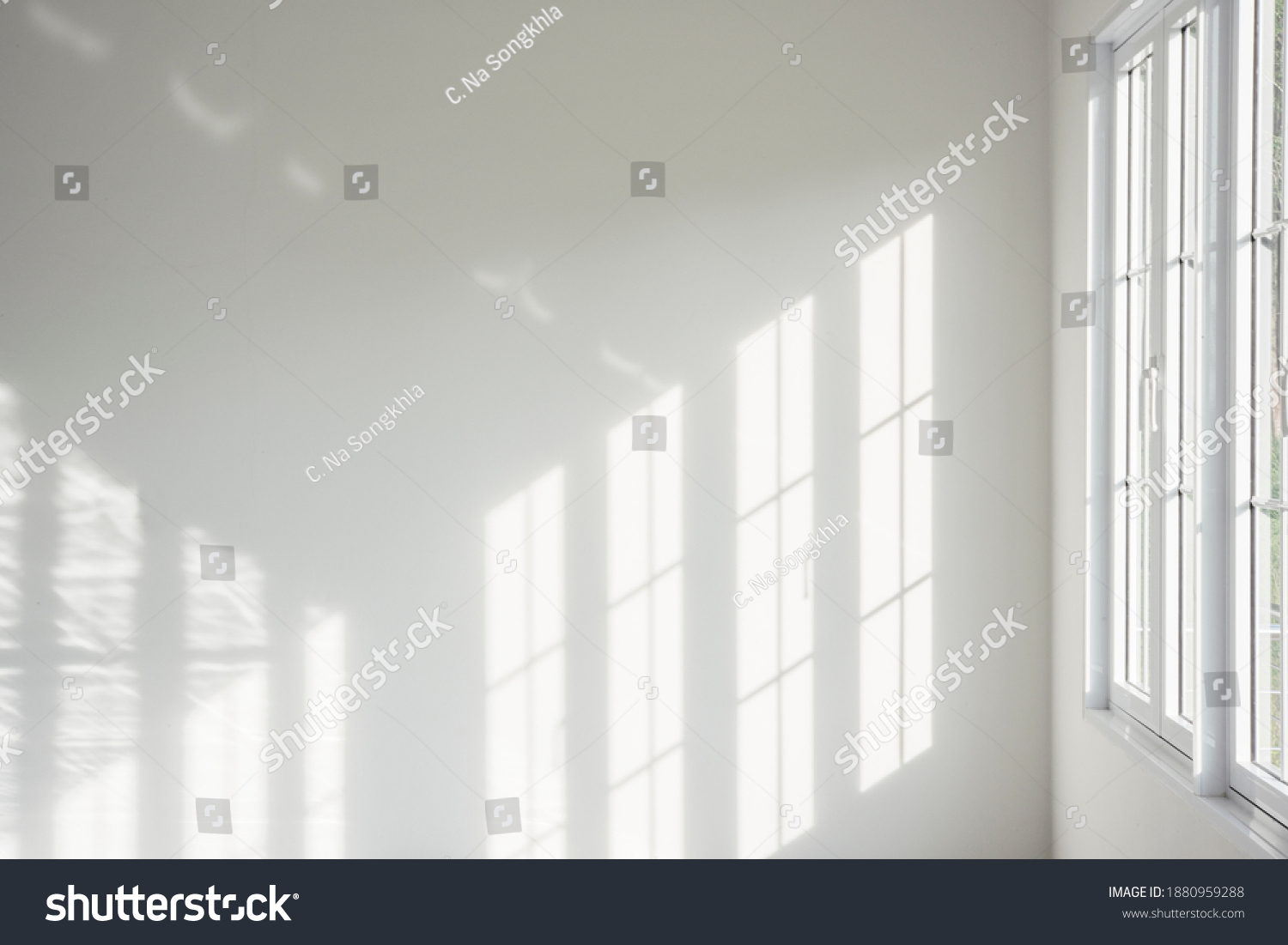 White room, glass windows, combined with the sunlight on the wall. #1880959288