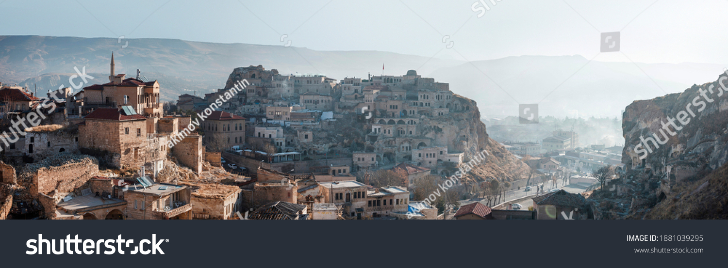 Turkey, Urgup - Panarama of the city in the morning from the mountain. View of the old stone mansions located in the gorge #1881039295