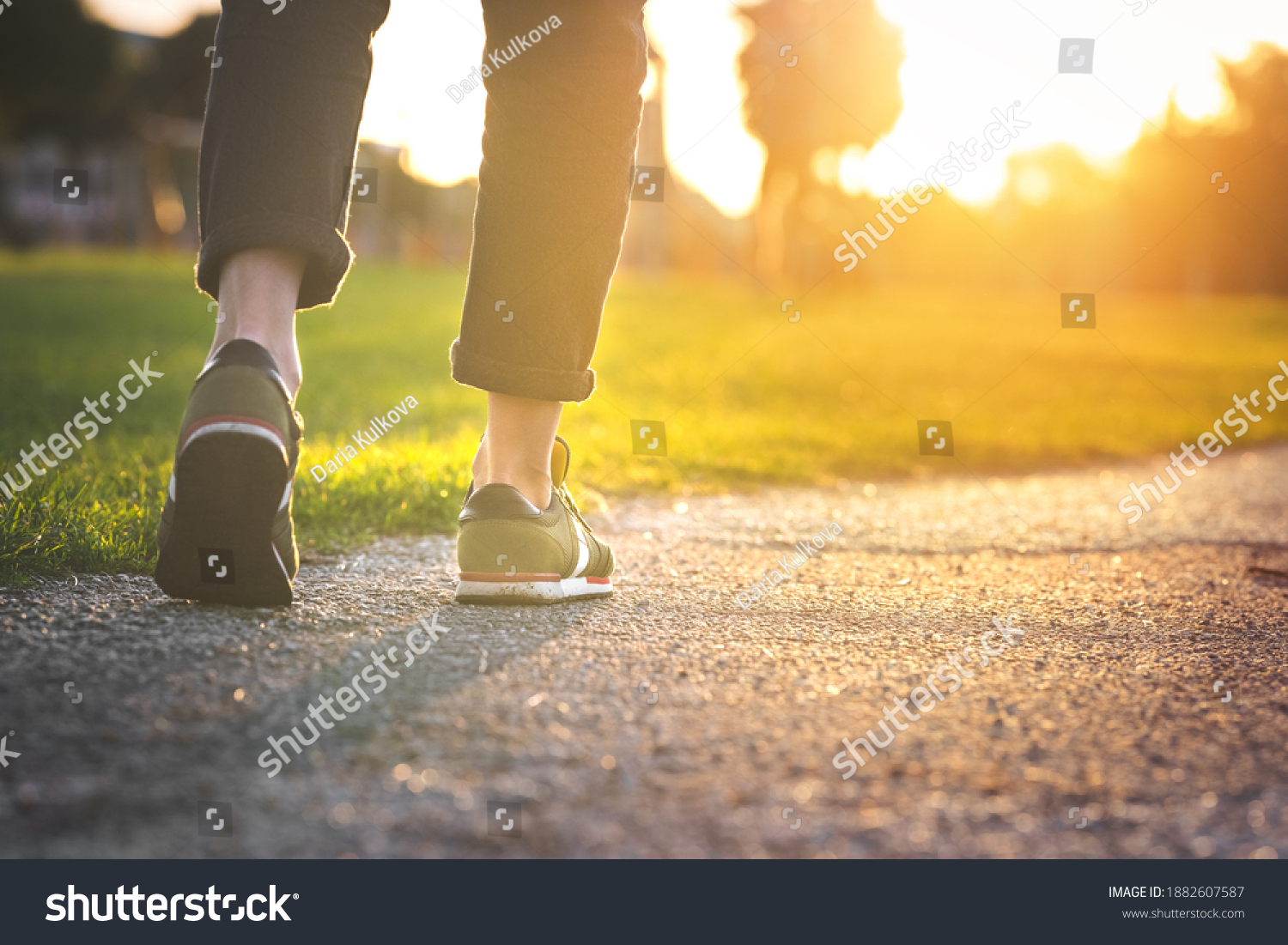 Woman walking in the park, outdoors. Closeup on shoe with rolled up jeans. Taking a step. New life concept #1882607587