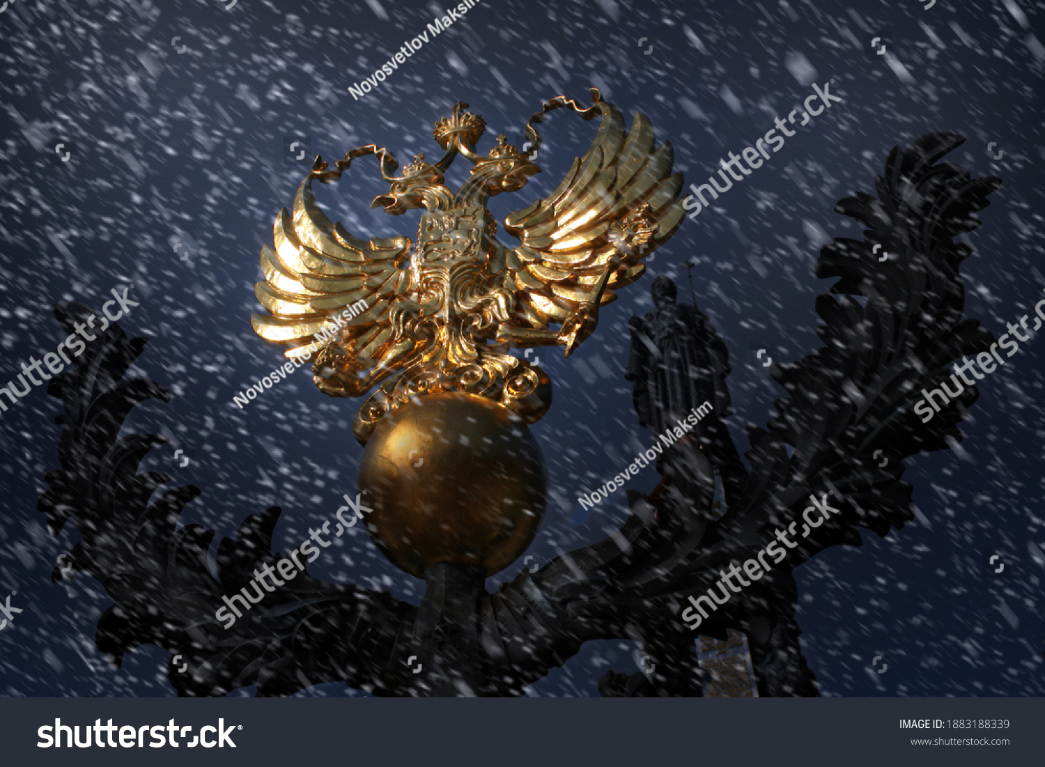 Coat of Arms of Russia is a Golden Double-Headed Eagle At night in Winter during a Snowfall. Concept Russia, News, Winter, Russian Federation, Politics, Sanctions, Moscow. #1883188339