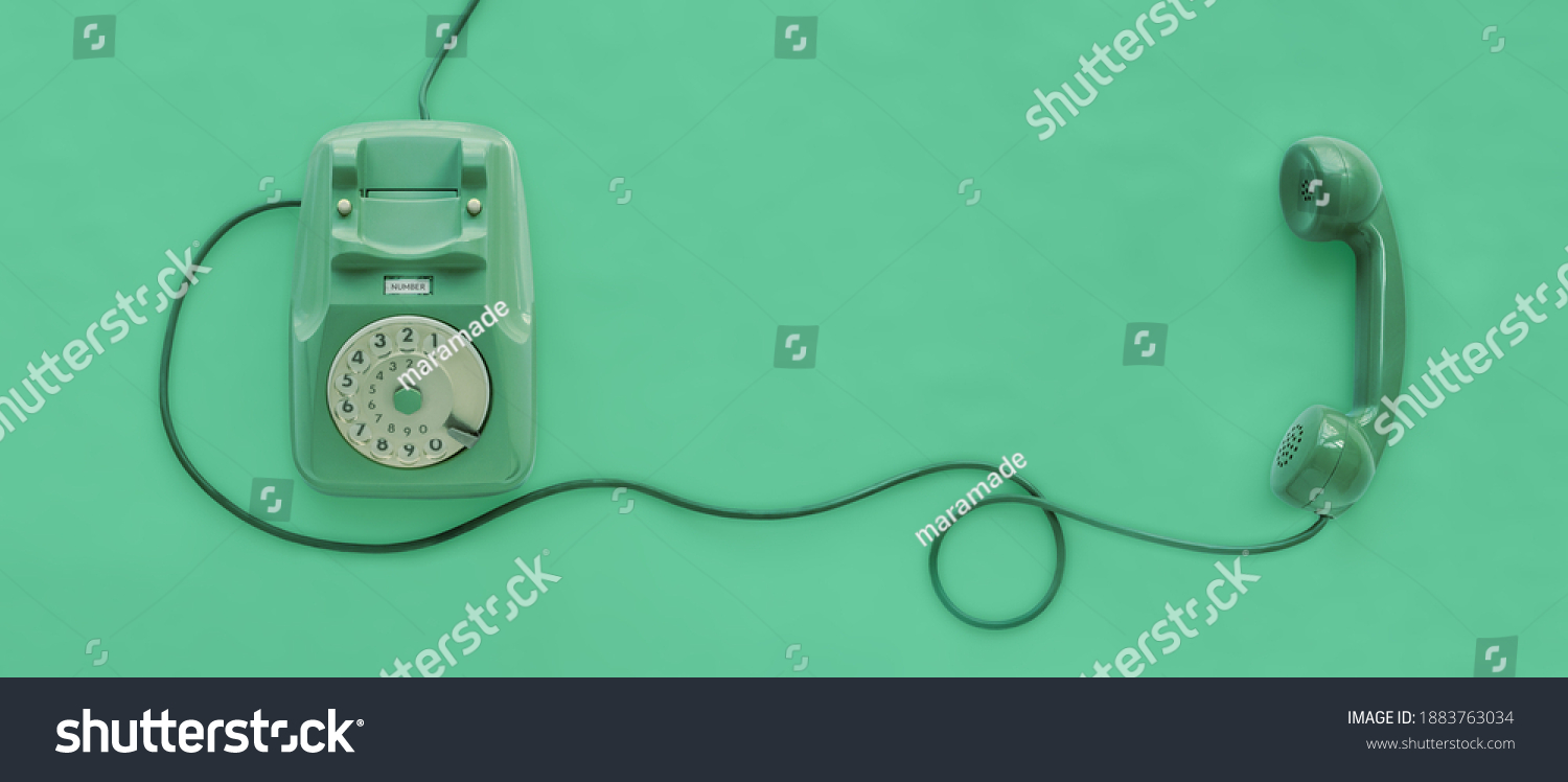 A green vintage dial telephone with green background. #1883763034