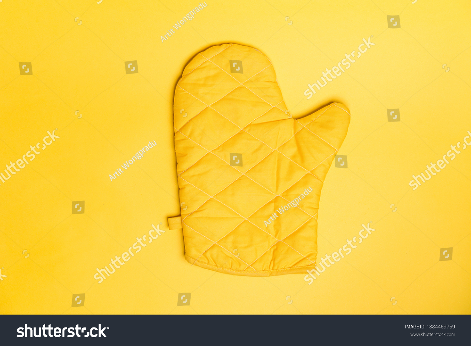 Top view of yellow oven gloves on yellow color background. Mockup for food banner and kitchen protection equipment. #1884469759