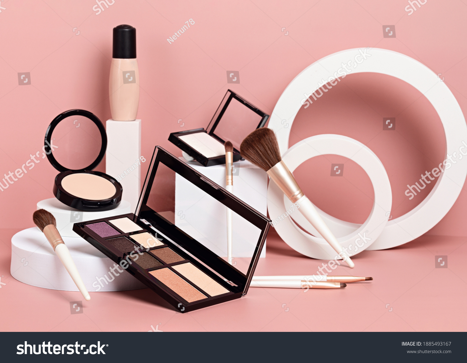 Make up products prsented on white podiums on pink pastel background. Mockup for branding and packaging presentation #1885493167