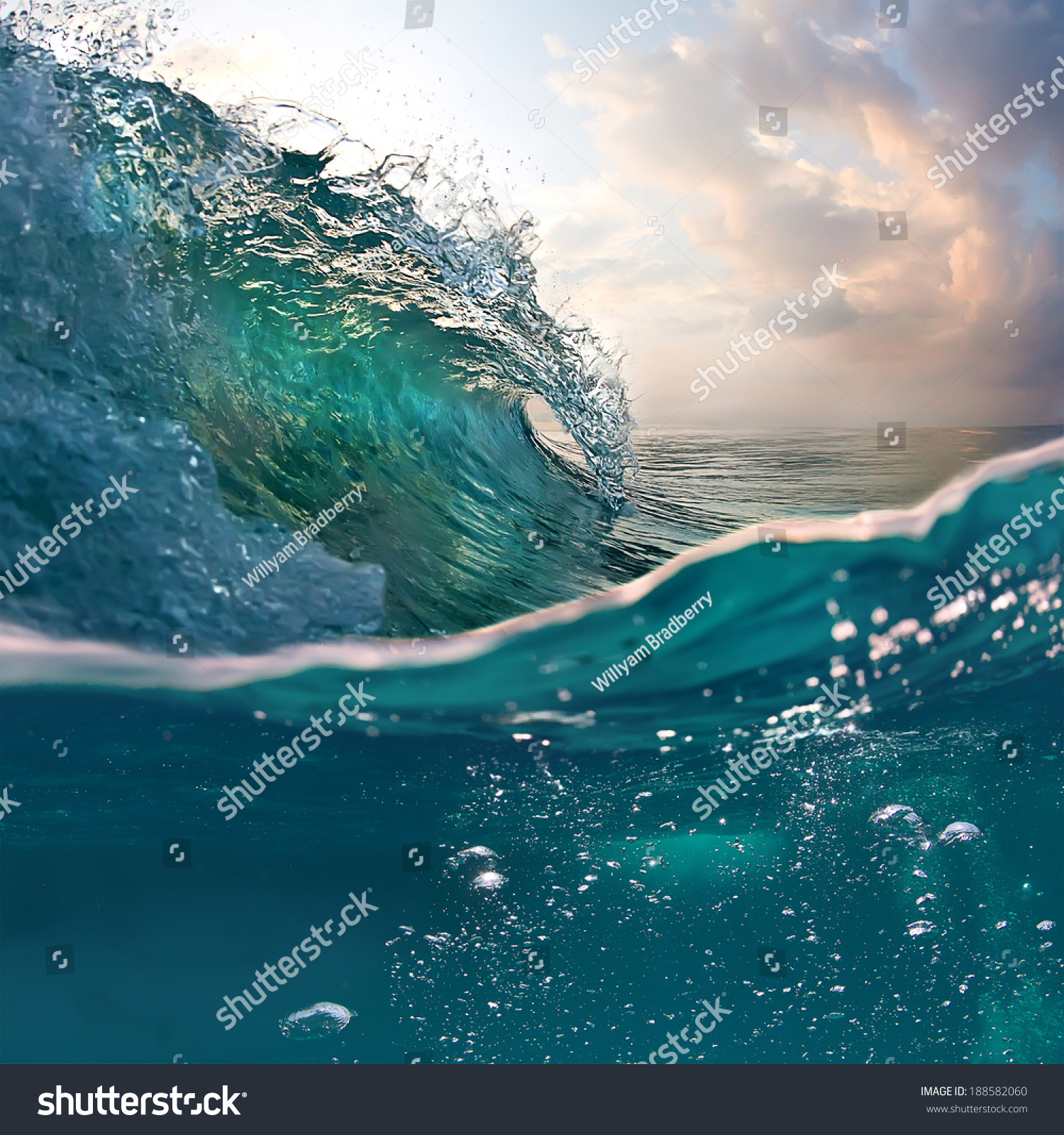Tropical sunset background. Beautiful colorful ocean wave breaking closing near sand beach #188582060