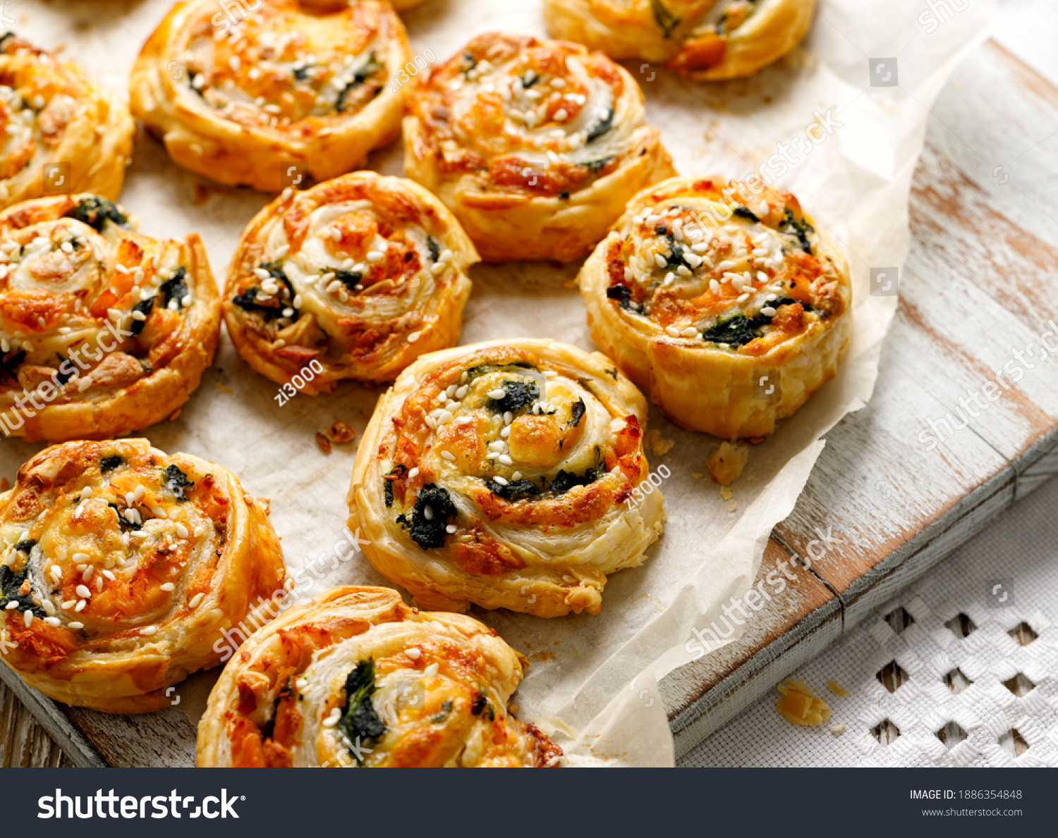 French Puff Pastry Pinwheels stuffed with salmon, cheese and spinach on on baking paper, close up view  #1886354848