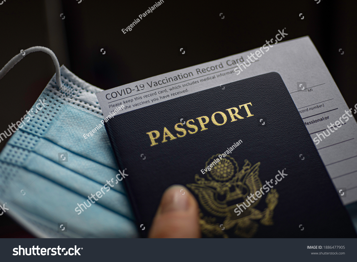 Blurred COVID-19 Vaccination Record card, Passport of USA and Medical Mask. Immune passport or certificate for travel concept.  #1886477905