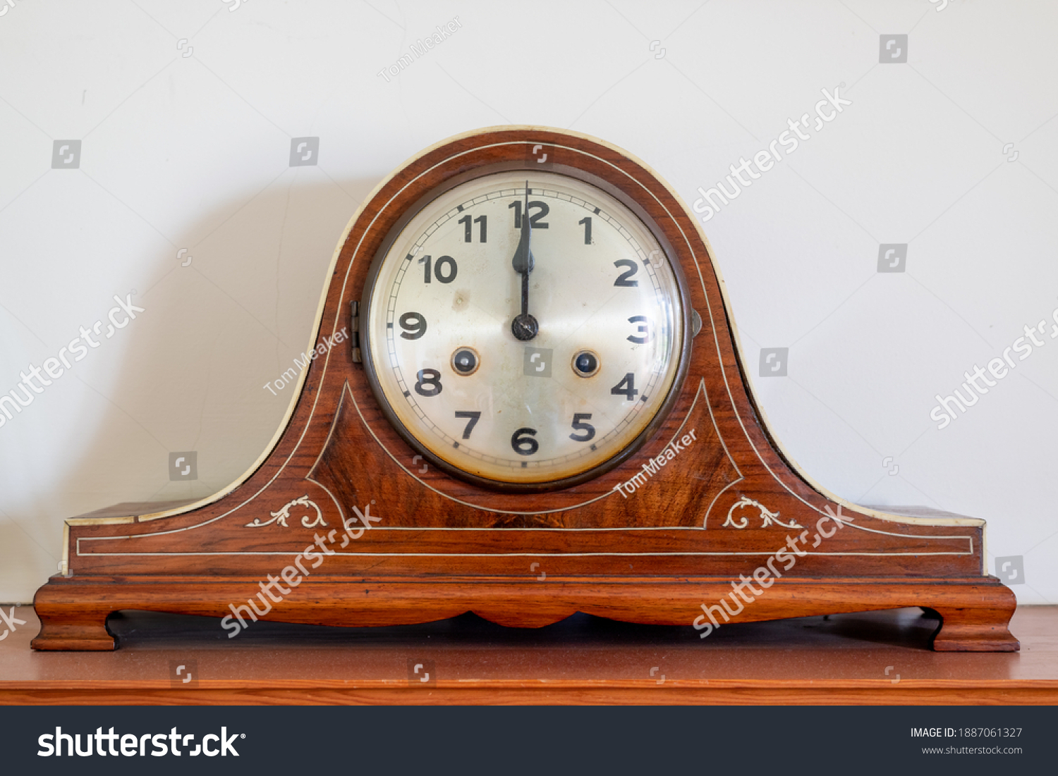 Close up of an antique clock showing 12 oclock #1887061327