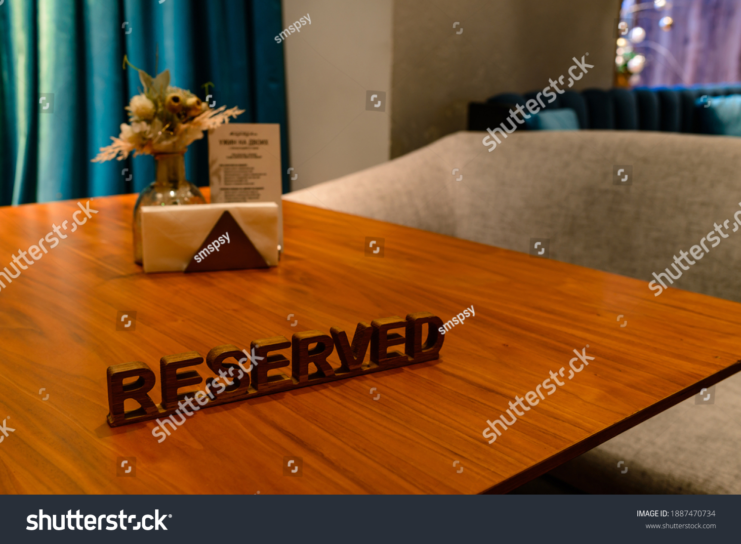 A modern idea for a reserved table with the inscription Reservation of your place. Idea restaurants the inscription reserved on a wooden table in a cafe #1887470734