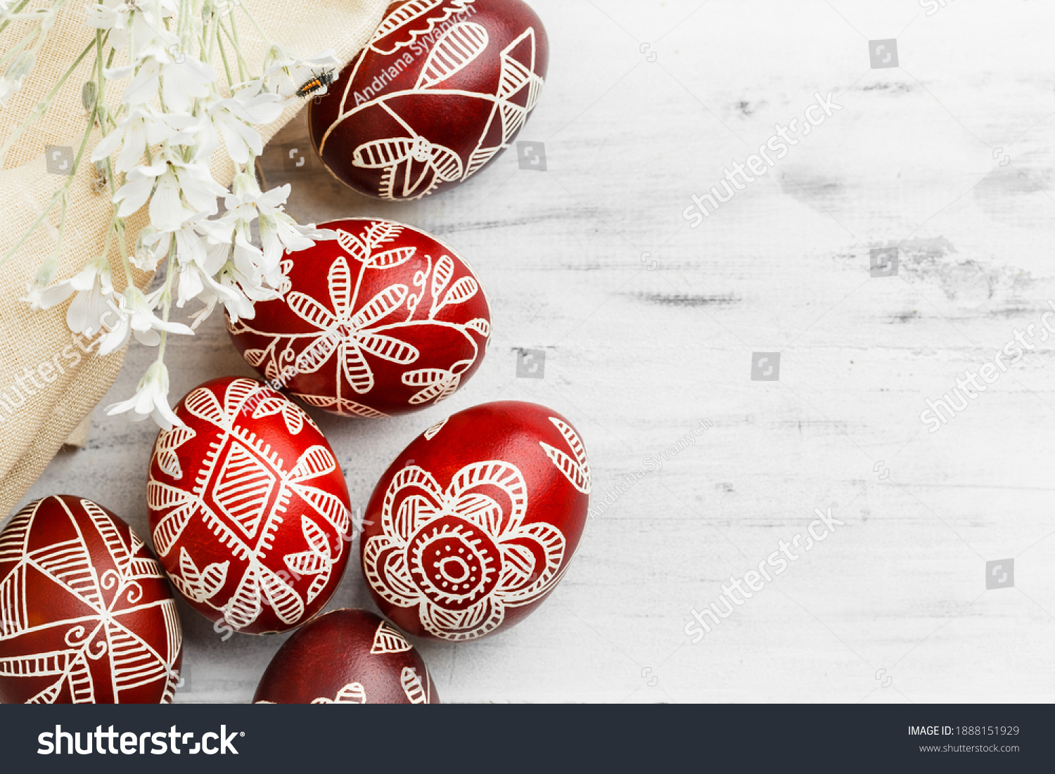 Red and white handmade Easter eggs. Ukrainian pysanka decorated with wax-resist dyeing technique. White wooden background with copy space for text #1888151929